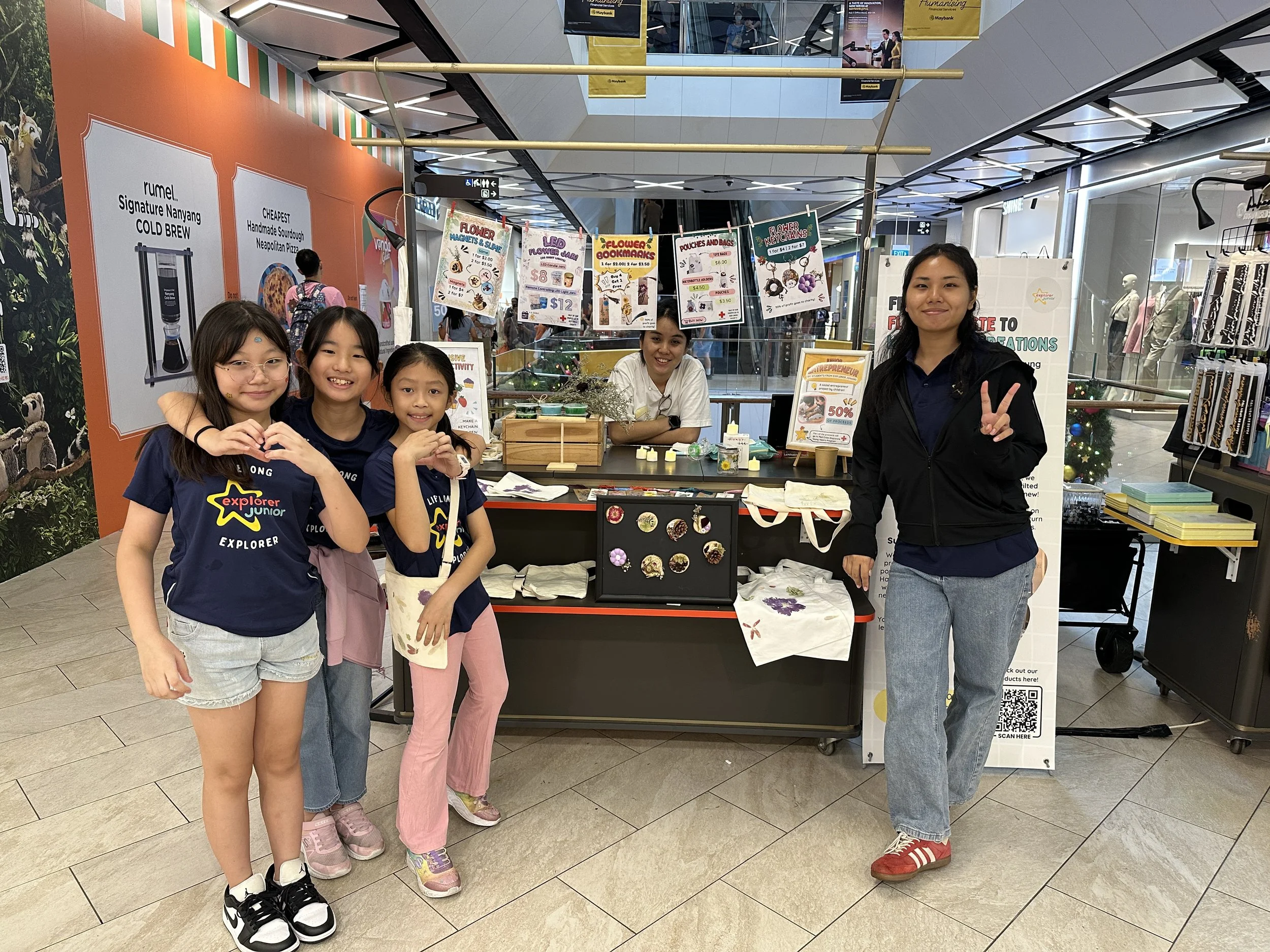 Children showcasing products they created using upcycled flowers during a STEM entrepreneurship learning programme