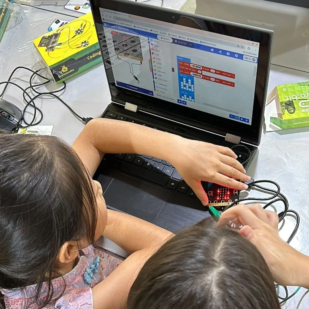 Children learning coding concepts during a Tech Saturday STEM workshop