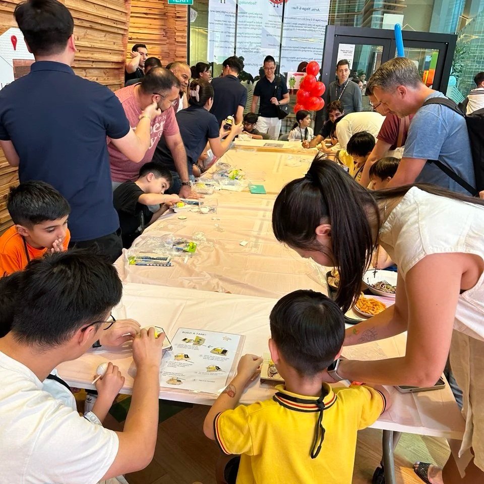 Children participating in hands-on STEM activities during a corporate family day organised by Explorer Junior