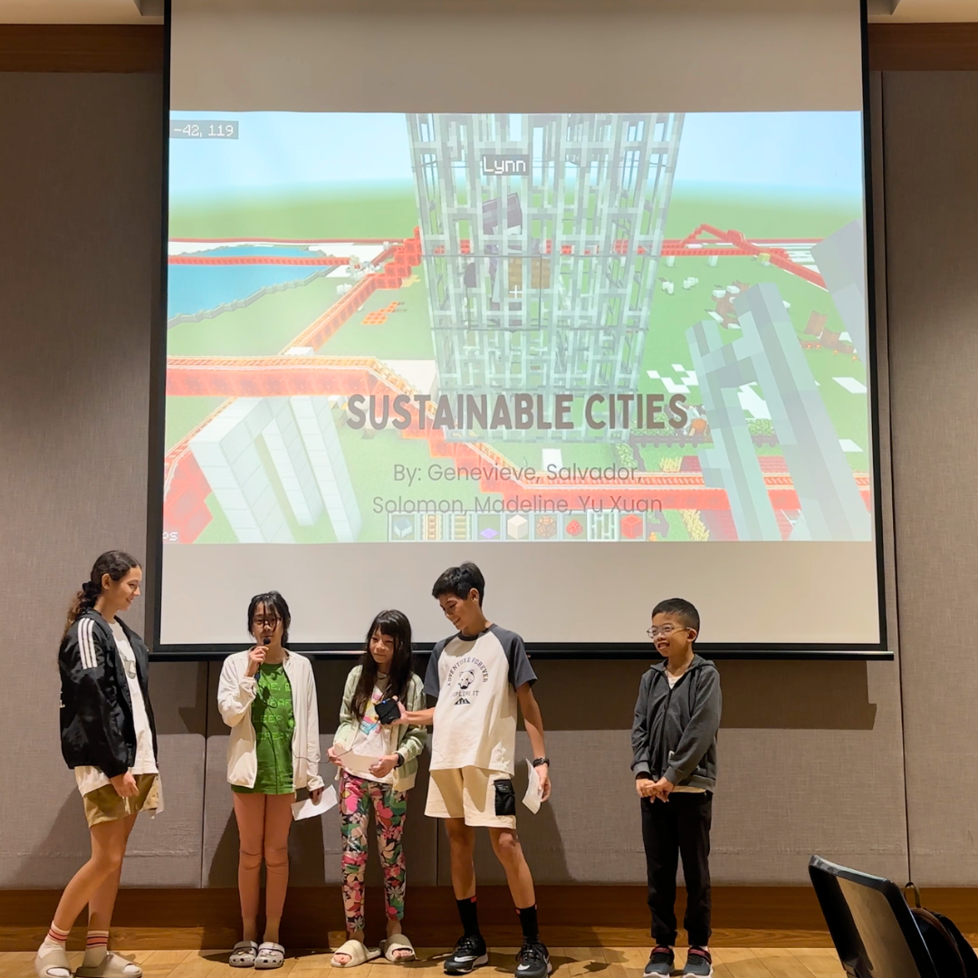 Group of children presenting their Minecraft sustainable city project on screen at an EcoVenturers presentation session