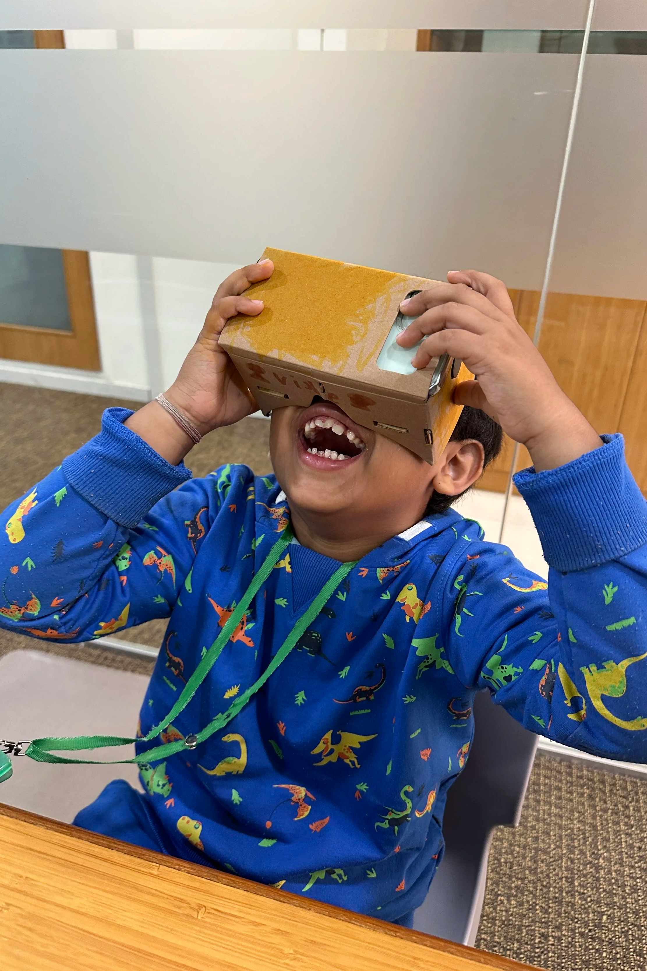 Child exploring VR concepts through hands-on STEM learning activity at Explorer Junior