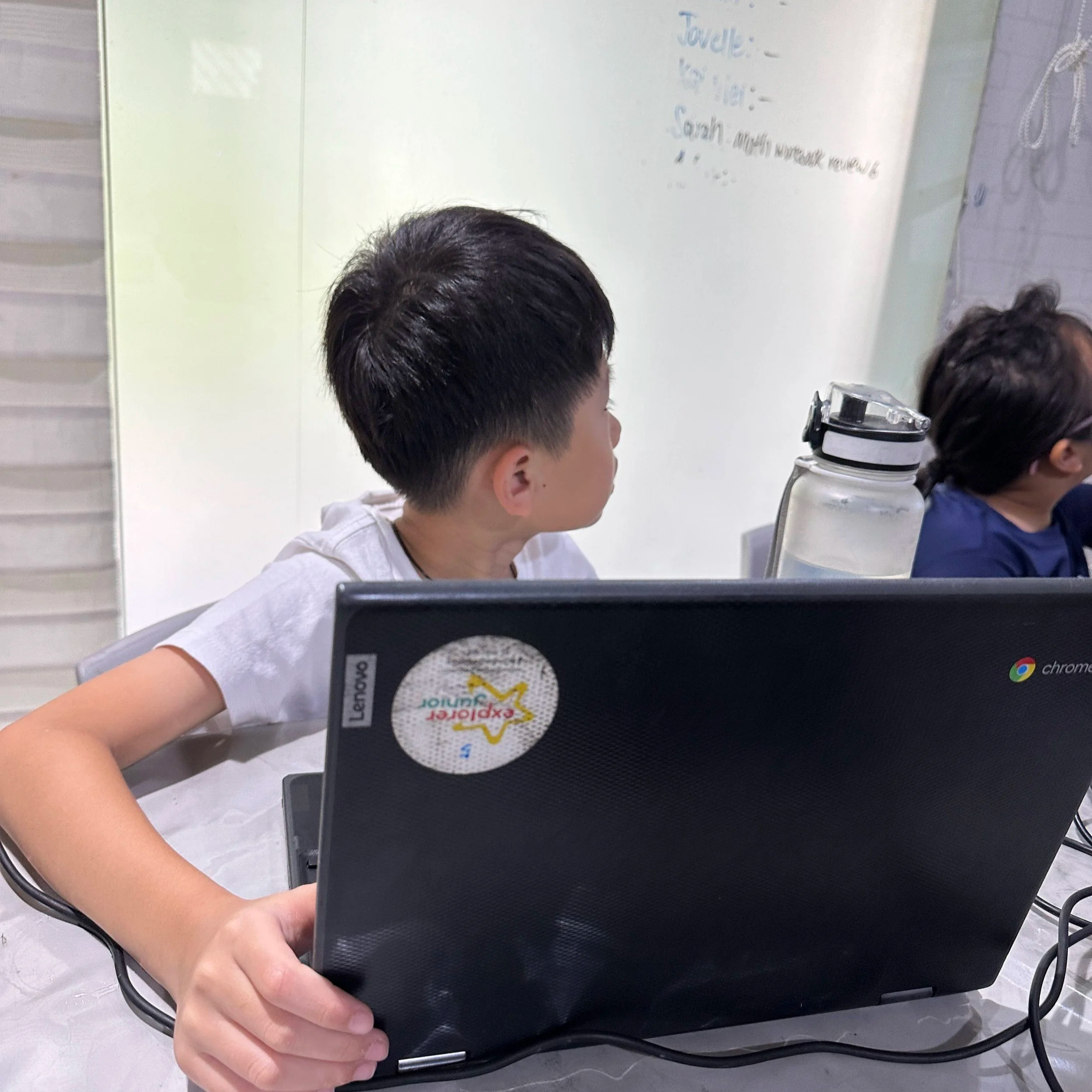 student listening to teacher while coding AI vision games