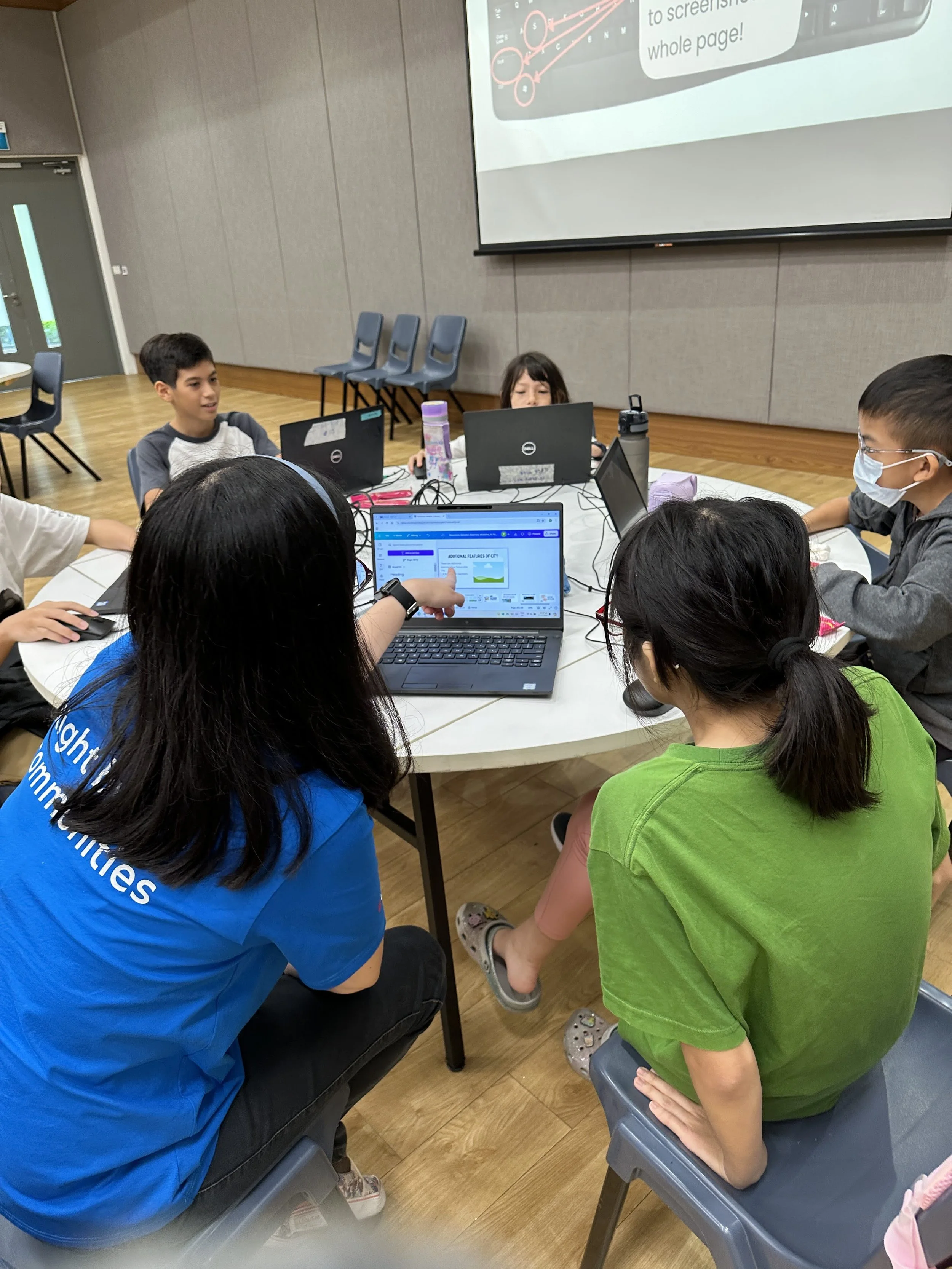 Volunteers from company guiding children with their build