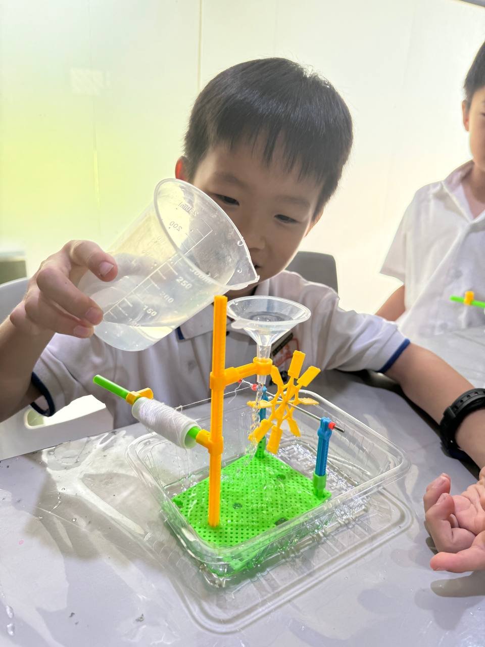 Student conducting a hands-on STEM experiment during Explorer Junior afterschool learning programme