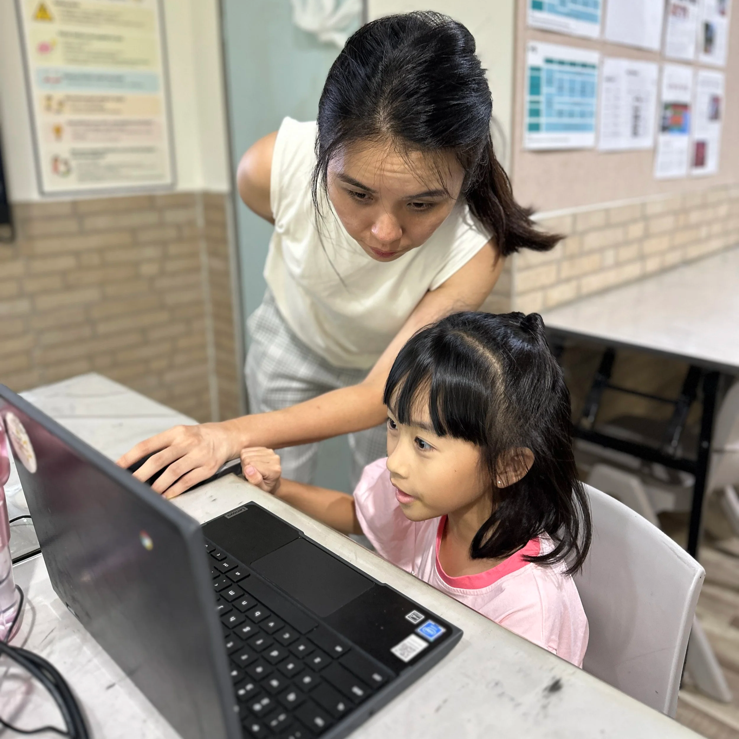 Teacher helping a student at a AI Coding class