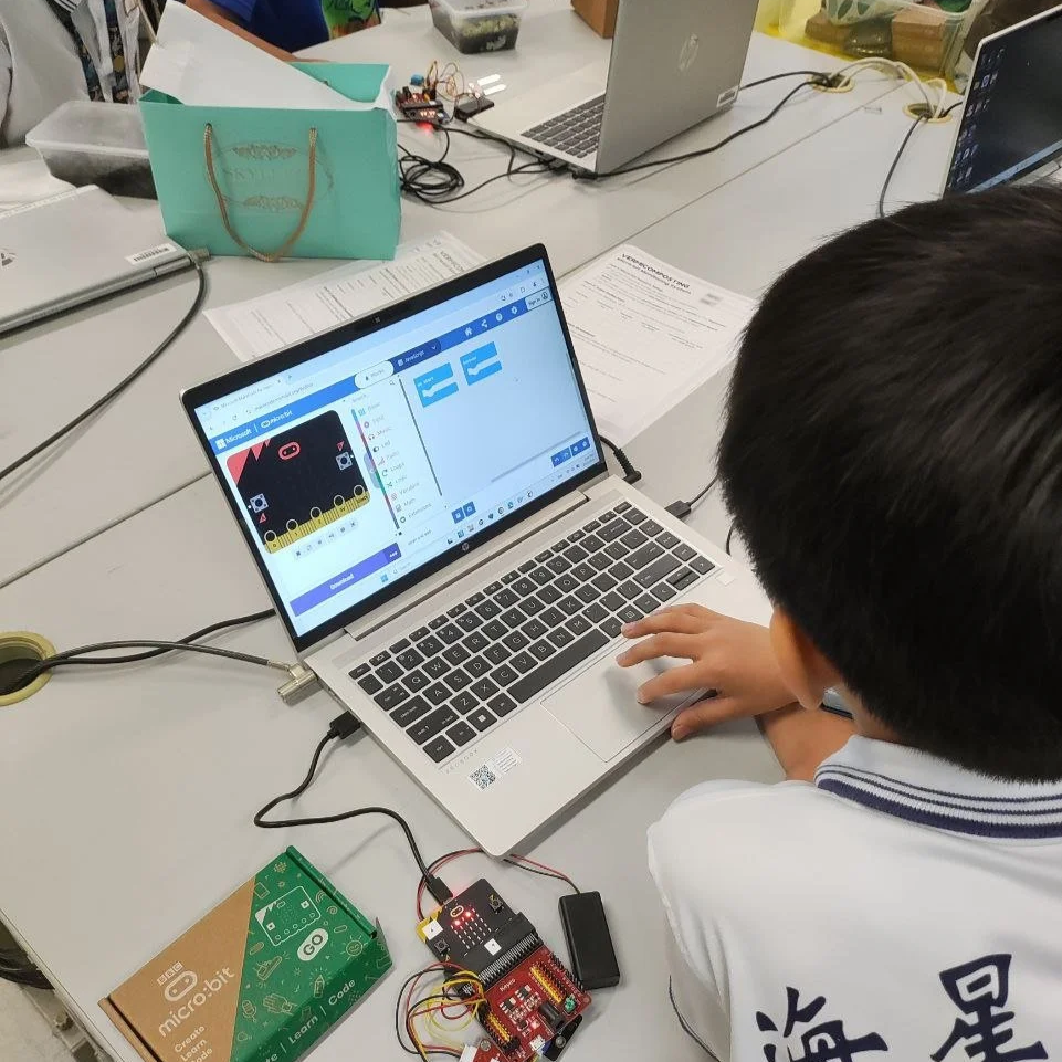 student coding game on laptop