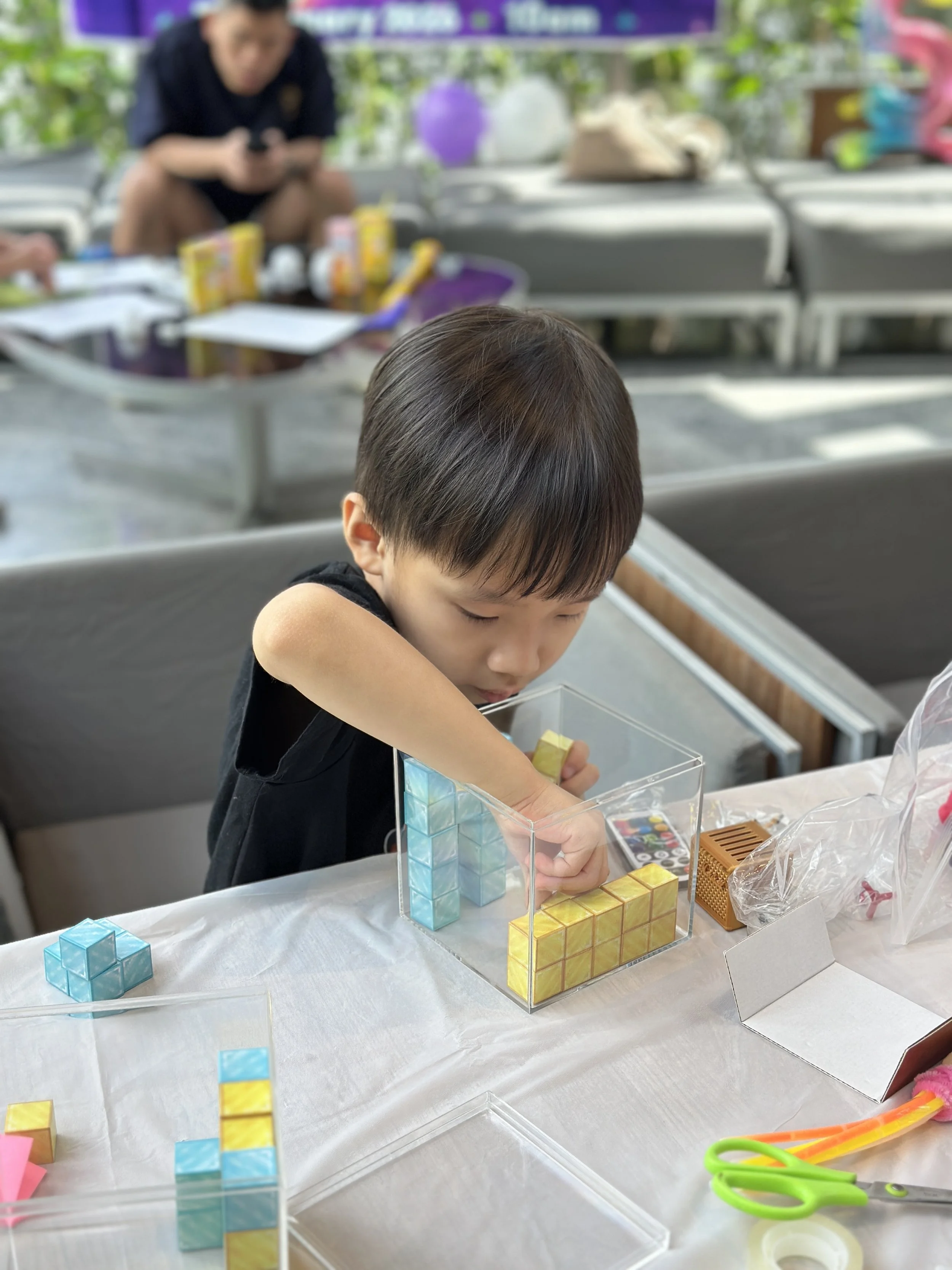 Children building creative engineering projects during a STEM-themed birthday celebration