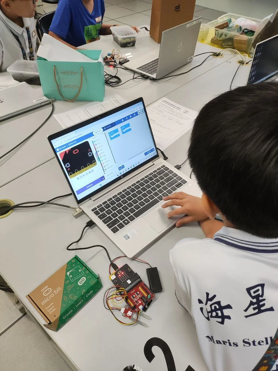 Students learning coding and digital technology during a STEM enrichment workshop