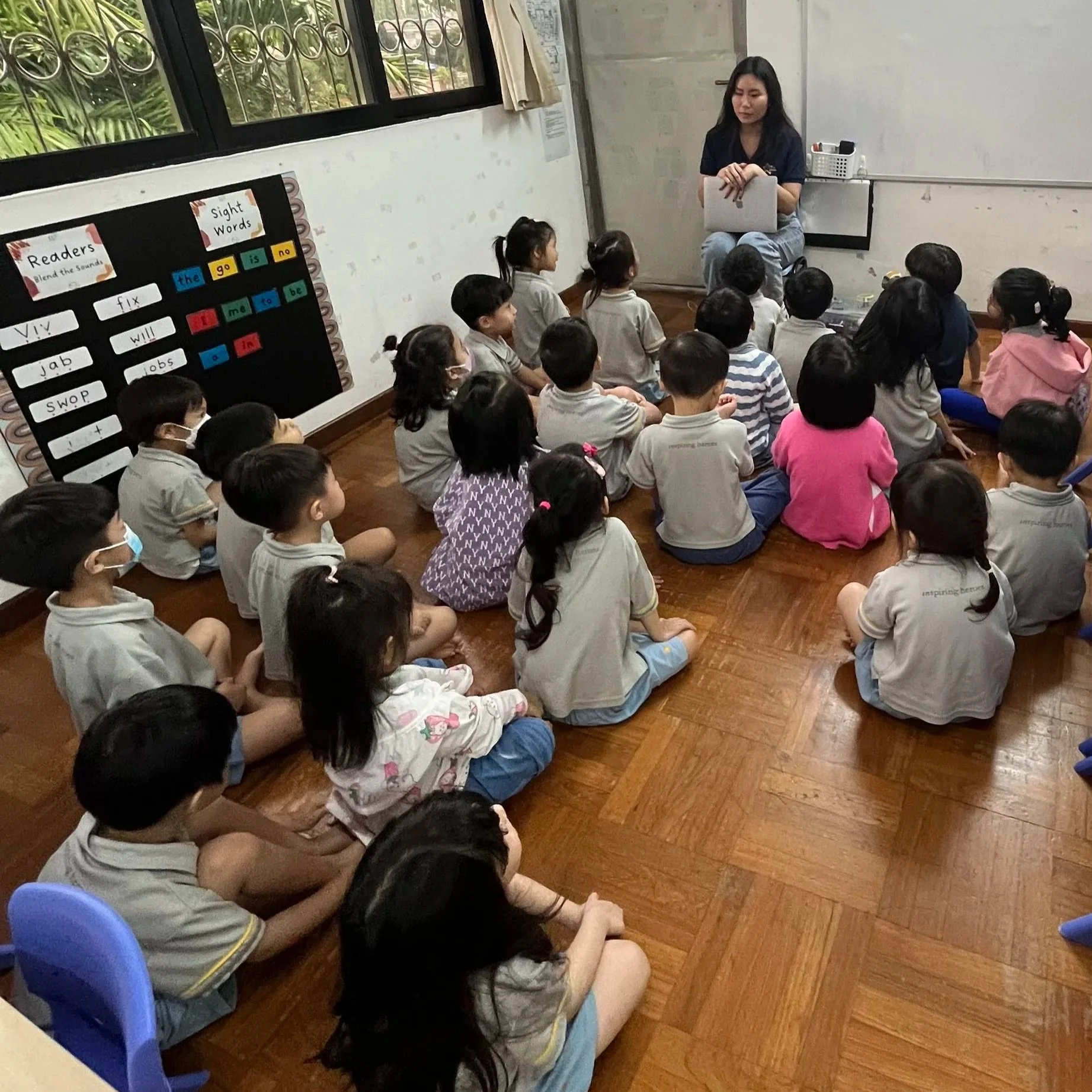 Educator guiding students through a hands-on science and engineering activity