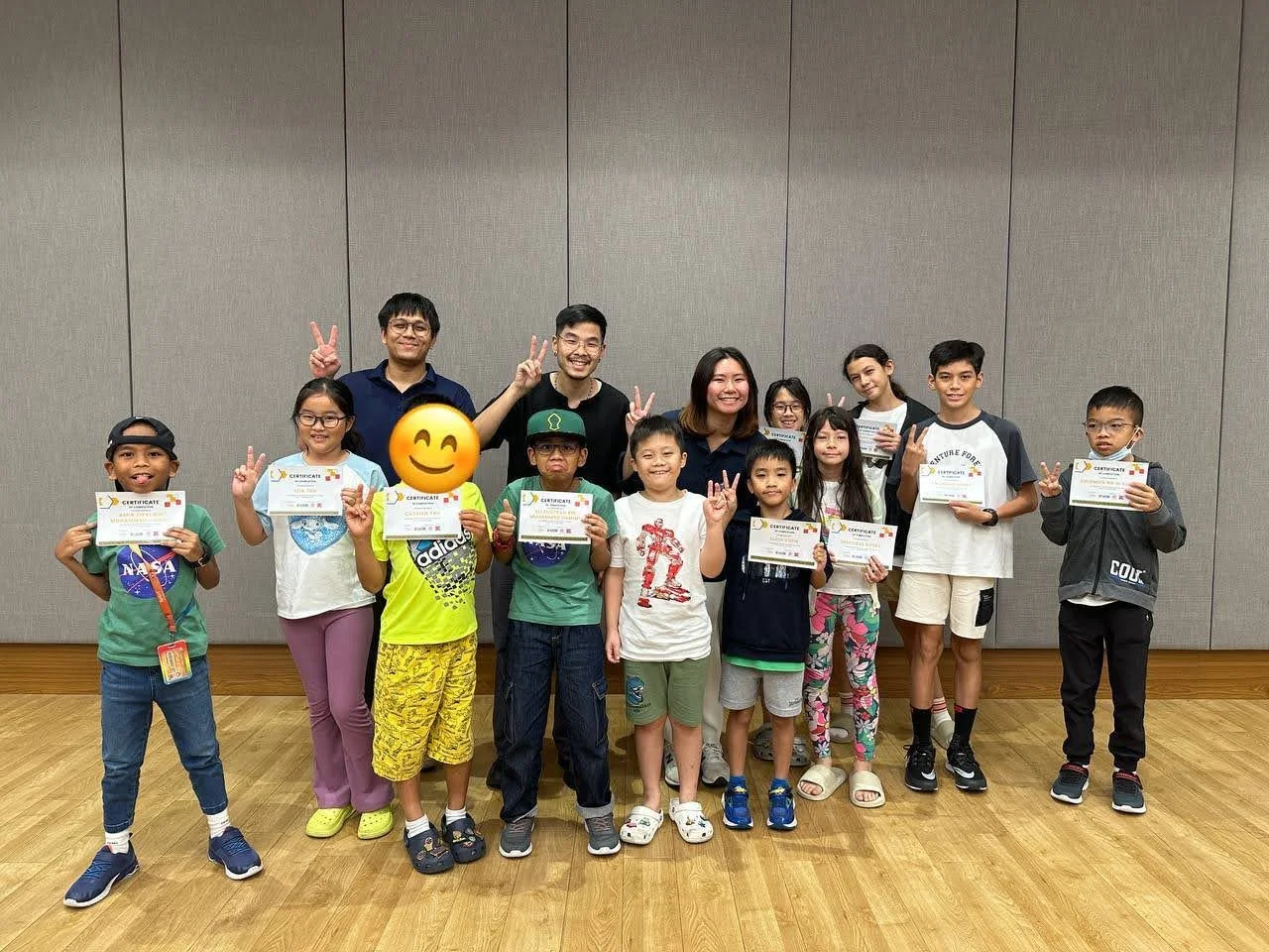 Children proudly holding certificates of completion with facilitators after an Explorer Junior EcoVenturers workshop