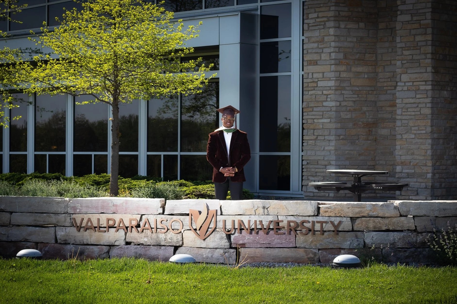 A graduation photo outside of a university