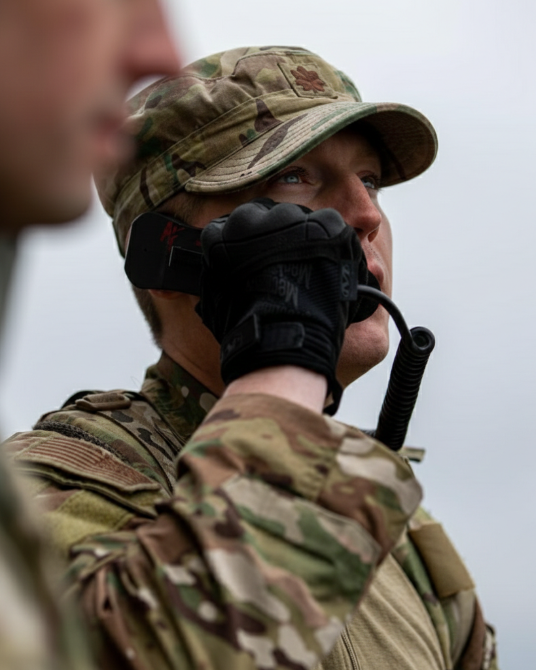 A Soldier looking at the sky on a radio