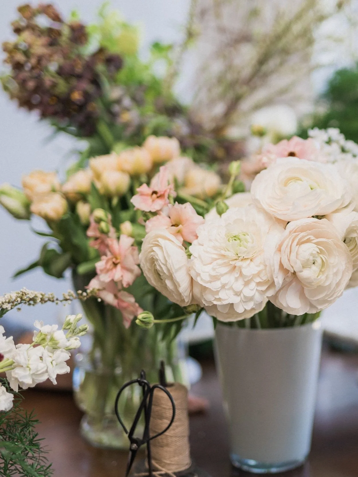 Blush ranunculus in a vase surrounded by other flowers for a Twig & Bloom workshop in Saskatoon.