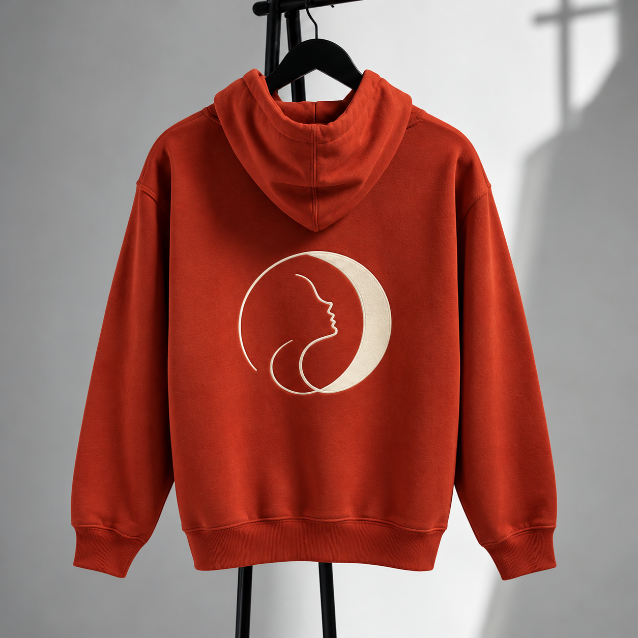 Rust Hoodie with Crescent Face Emblem.png