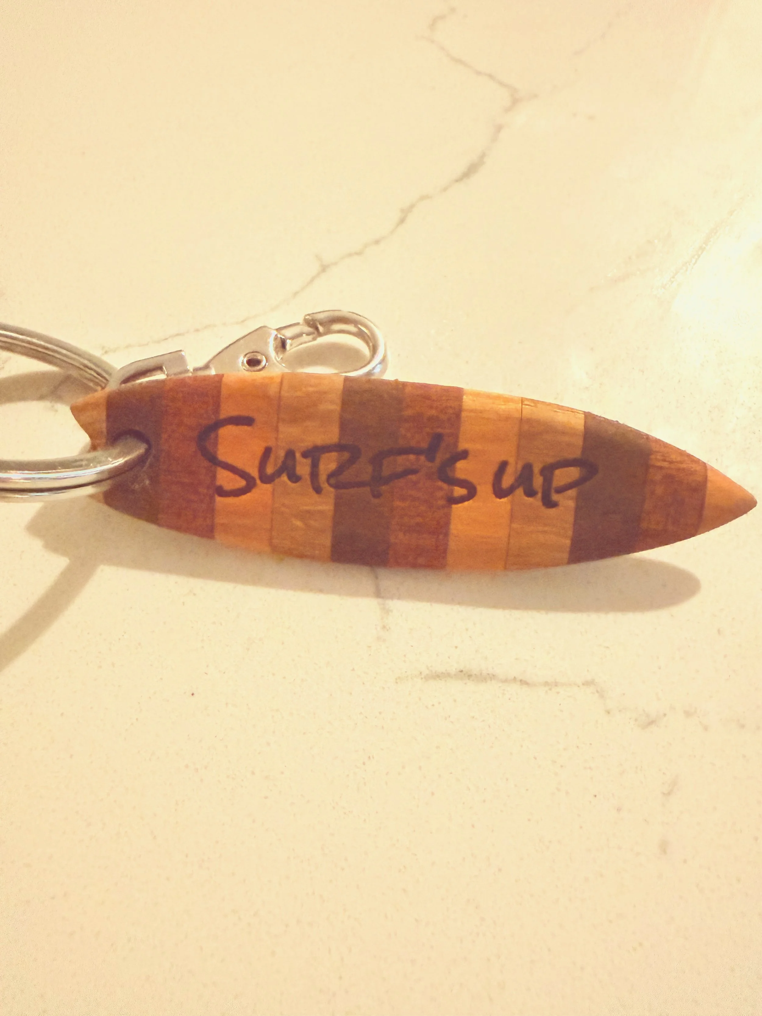 Made with and for our nephews. They picked out everything and we helped it become reality.  This is a little surfboard for a keychain.