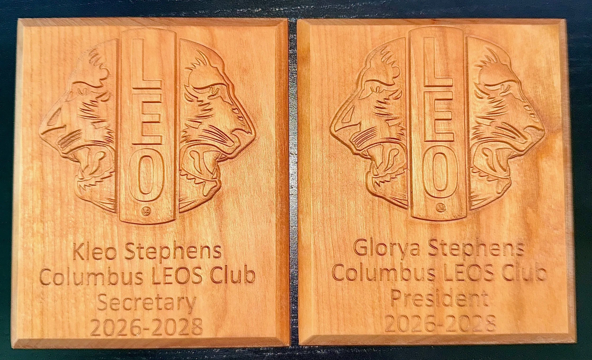 A couple 5" x 6" plaques carved from cherry hardwood. Each come with a 3D carving of the LEO Lions logo and personal details. A keyhole is included on the back for hanging.