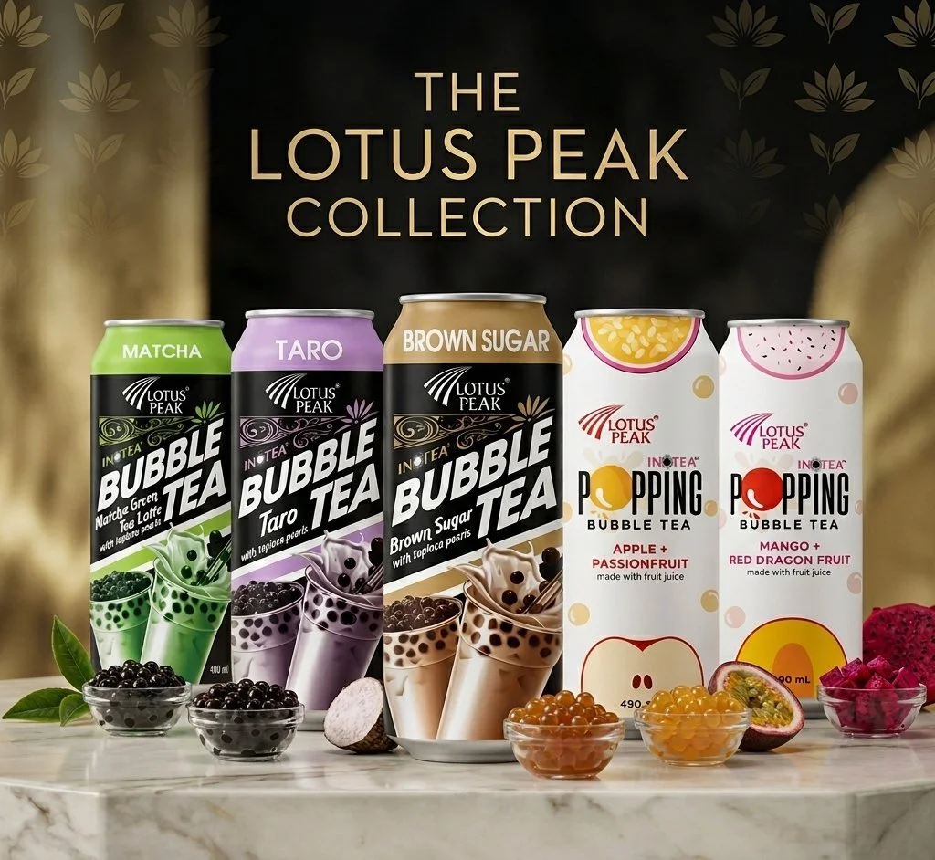 Five cans of Lotus Peak bubble tea flavors on a marble surface, with small bowls of tapioca pearls and fruit slices in front. The flavors are Matcha, Taro, Brown Sugar, Apple + Passionfruit, and Mango + Red Dragon Fruit.