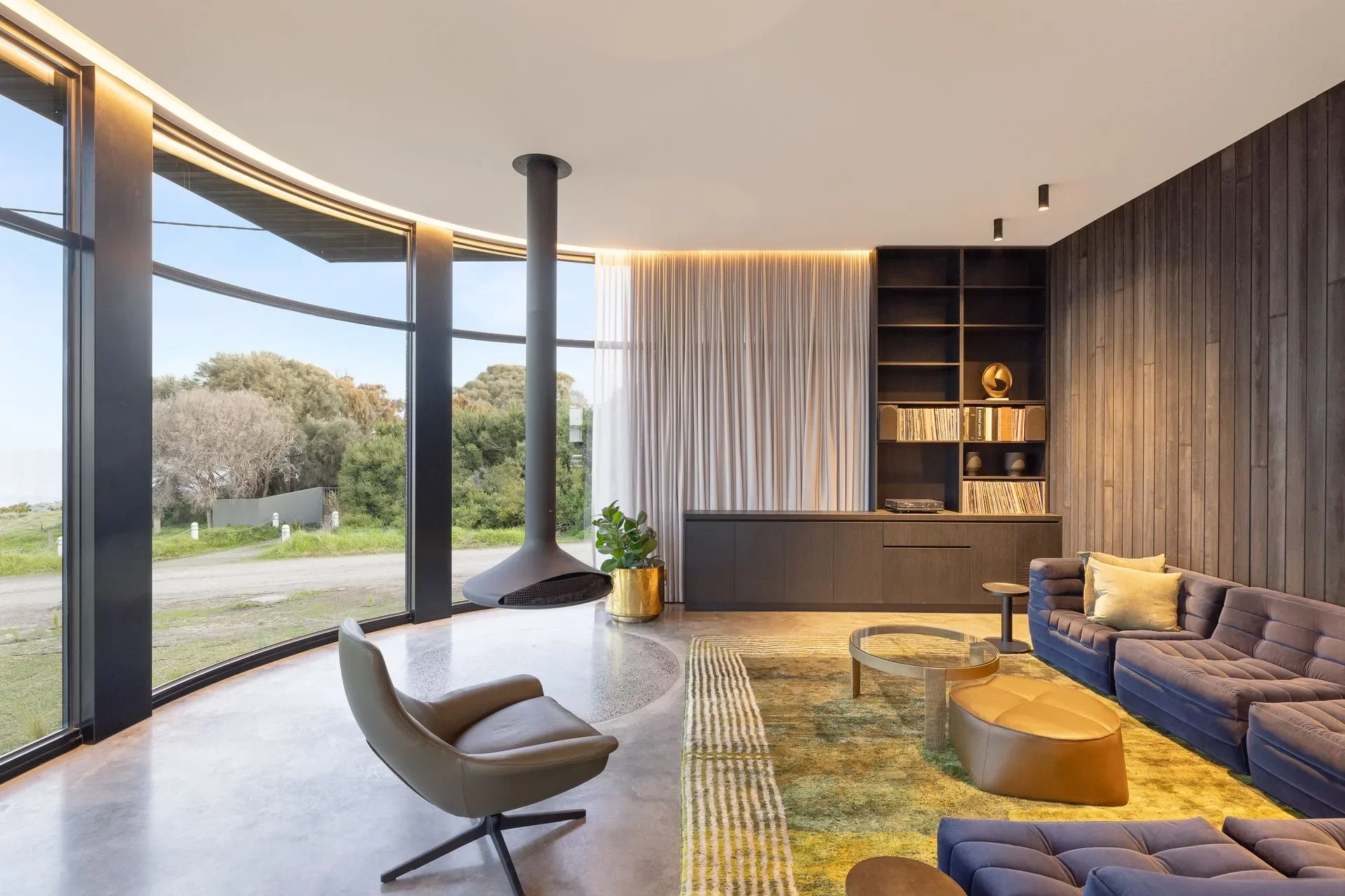 Floating fireplace with panoramic floor to ceiling windows with views of the Kilcunda Coastline