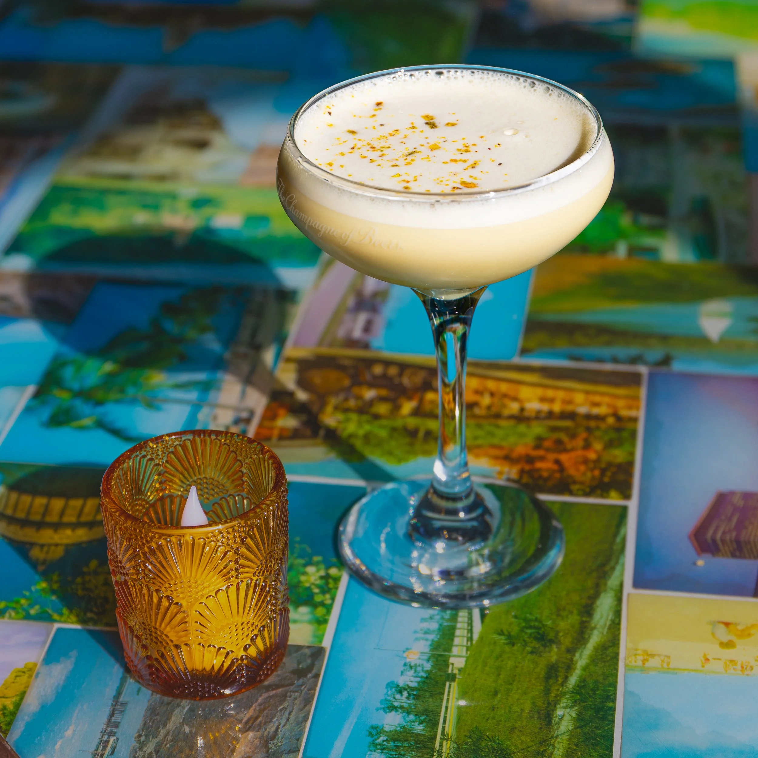 A creamy looking cocktail in a coupe glass