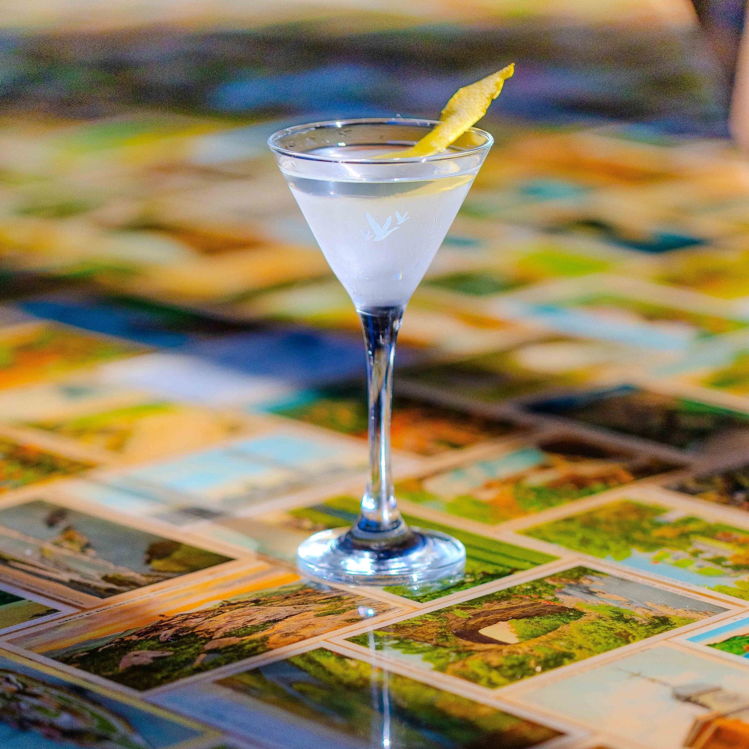 A martini cocktail with a lemon twist
