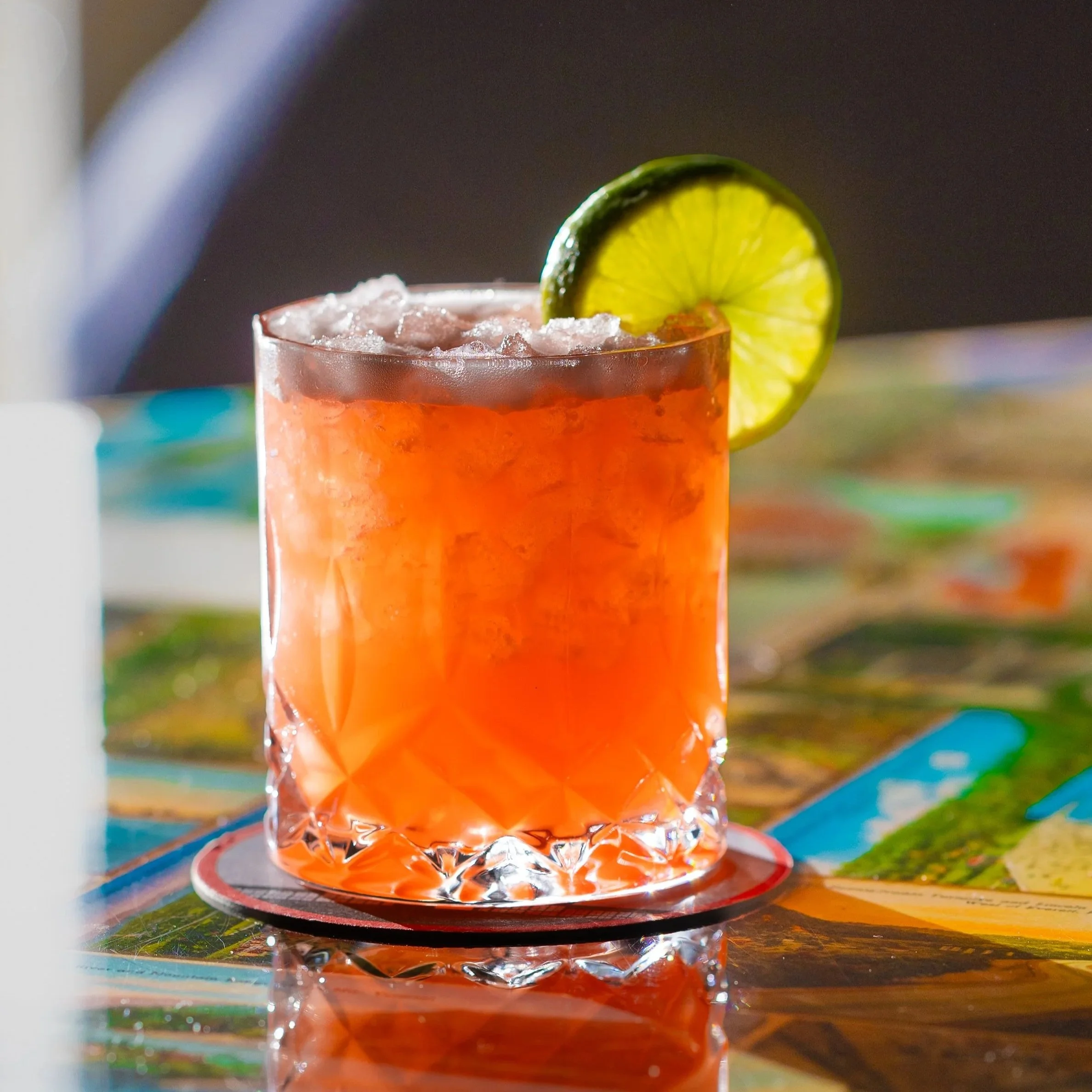 A bright Orange Cocktail in a lowball Glass