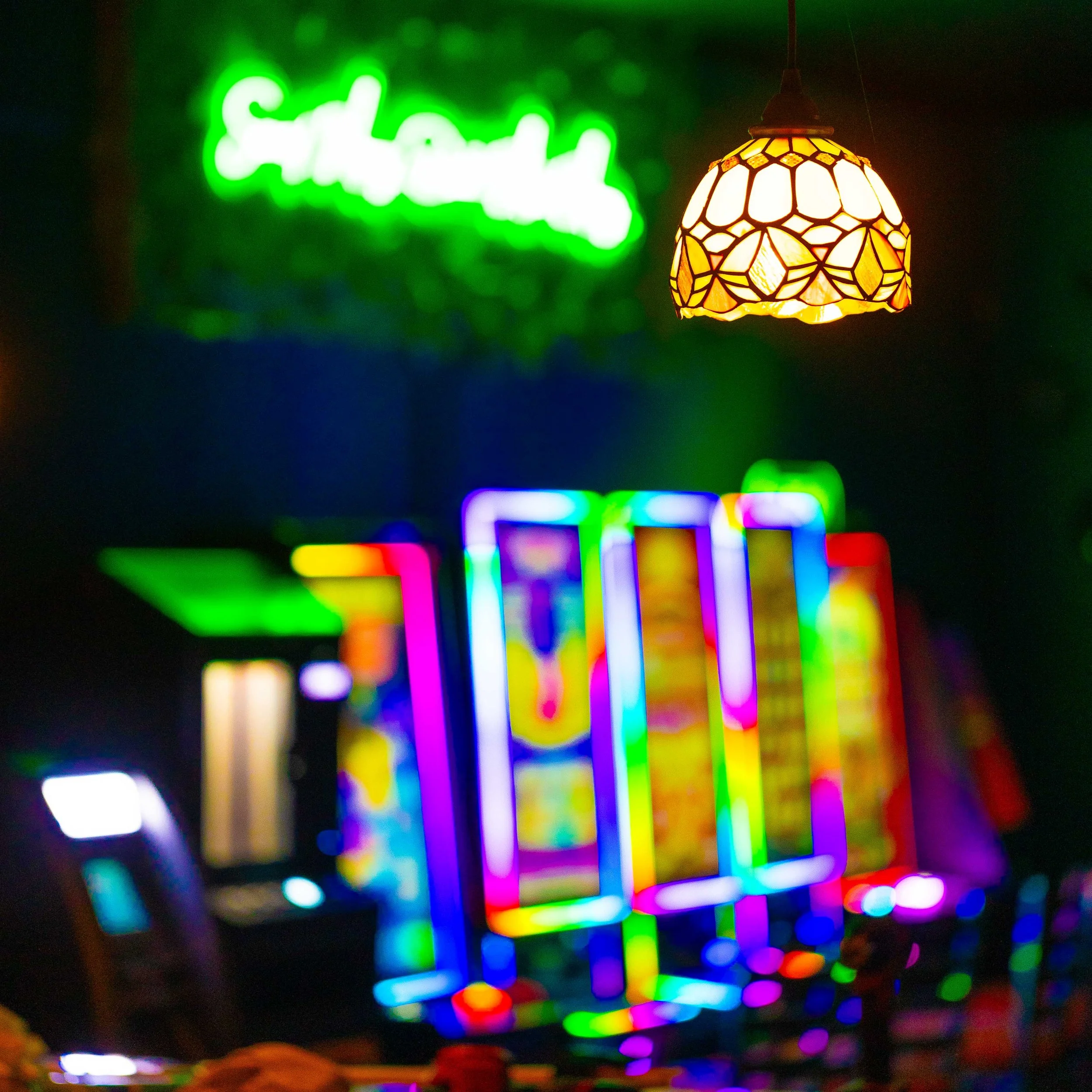 Out of Focus Rainbow Neon in a dark bar