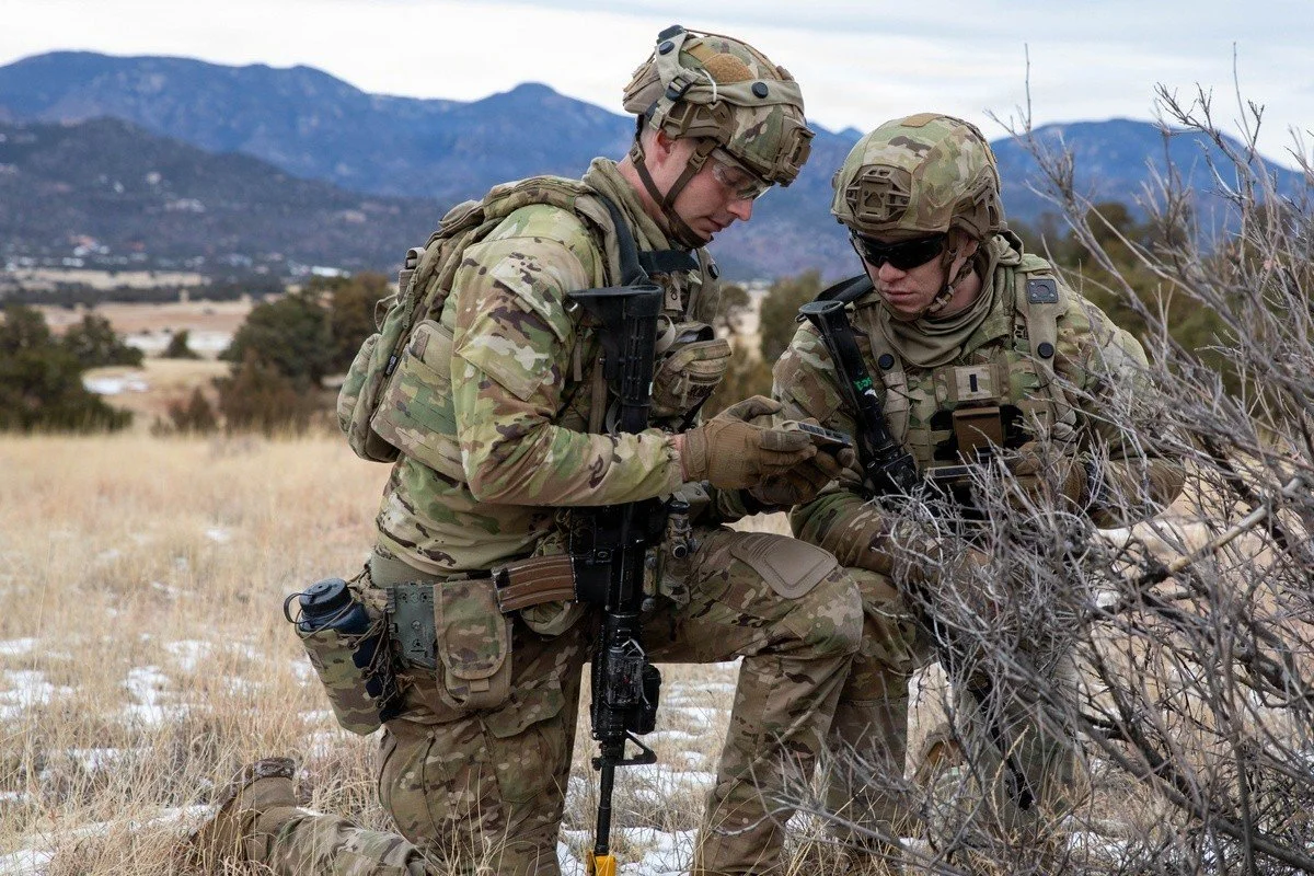 Two 4th Infantry Division leaders review shared digital information on an ATAK device during Ivy Sting 4 at Fort Carson.