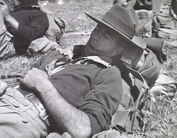 SEYMOUR - ONE OF THE 2/2 PIONEERS ENJOYS A SLEEP DURING A HALT IN THE ROUTE MARCH. ARMY. TRAINING IN AUST.