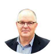 Darren Smith- A portrait of a middle-aged man with glasses, wearing a dark blazer and a light blue shirt, against a white background.