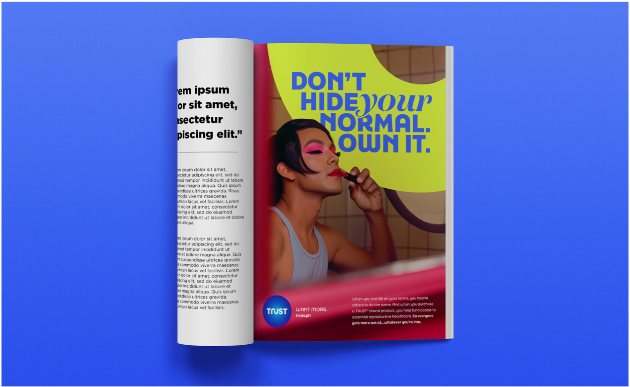 An open magazine displaying a colorful advertisement with a woman applying lipstick. The ad features bold text saying "Don't hide your normal. Own it." and a promotional message about trust and reproductive healthcare.
