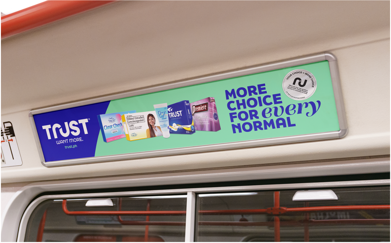 Advertisment on a metro vehicle promoting Trust pharmacy with various healthcare products and the slogan 'More choice for every normal'.
