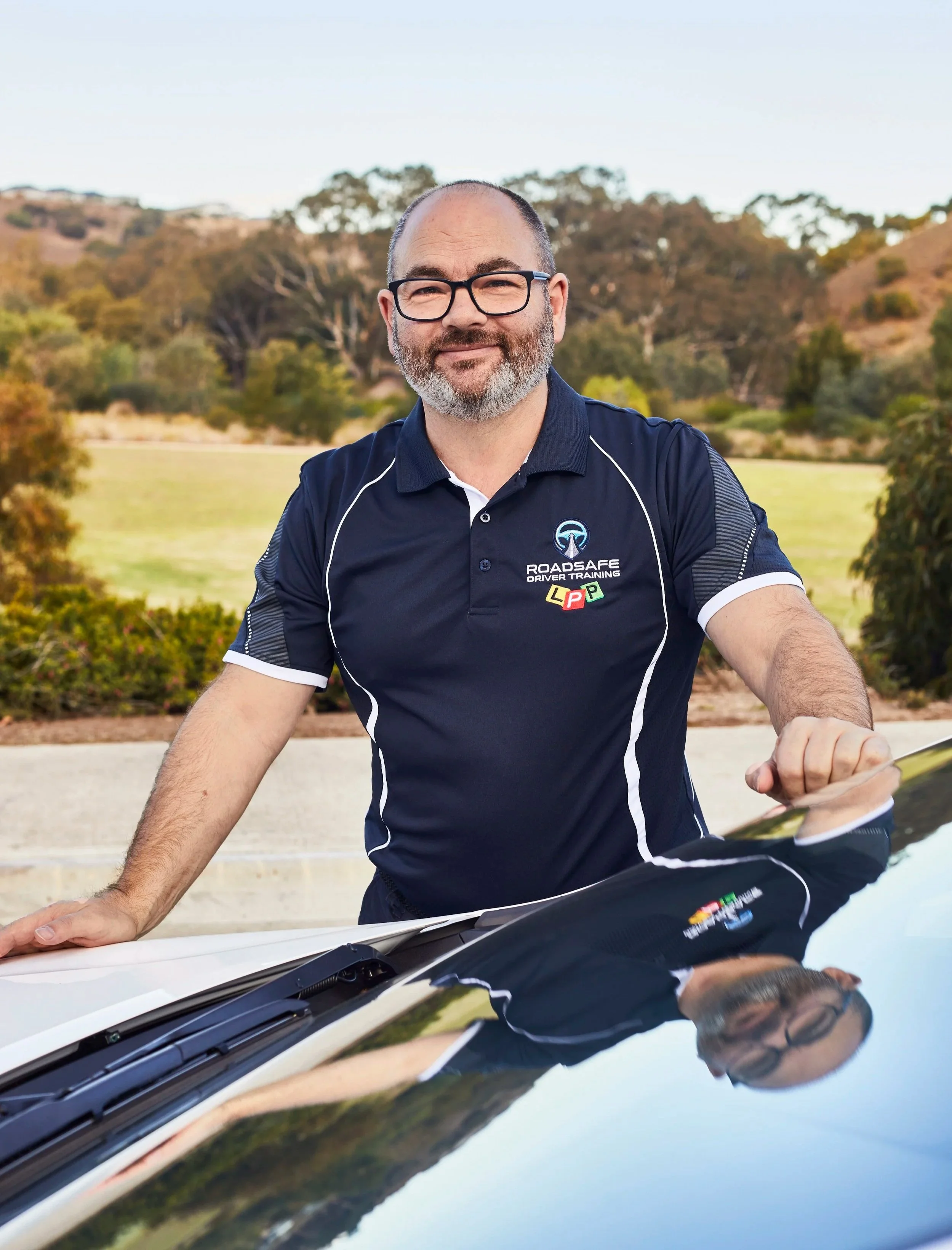 Ben D'Ornay standing beside the RoadSafe Driver Training vehicle in Geelong.