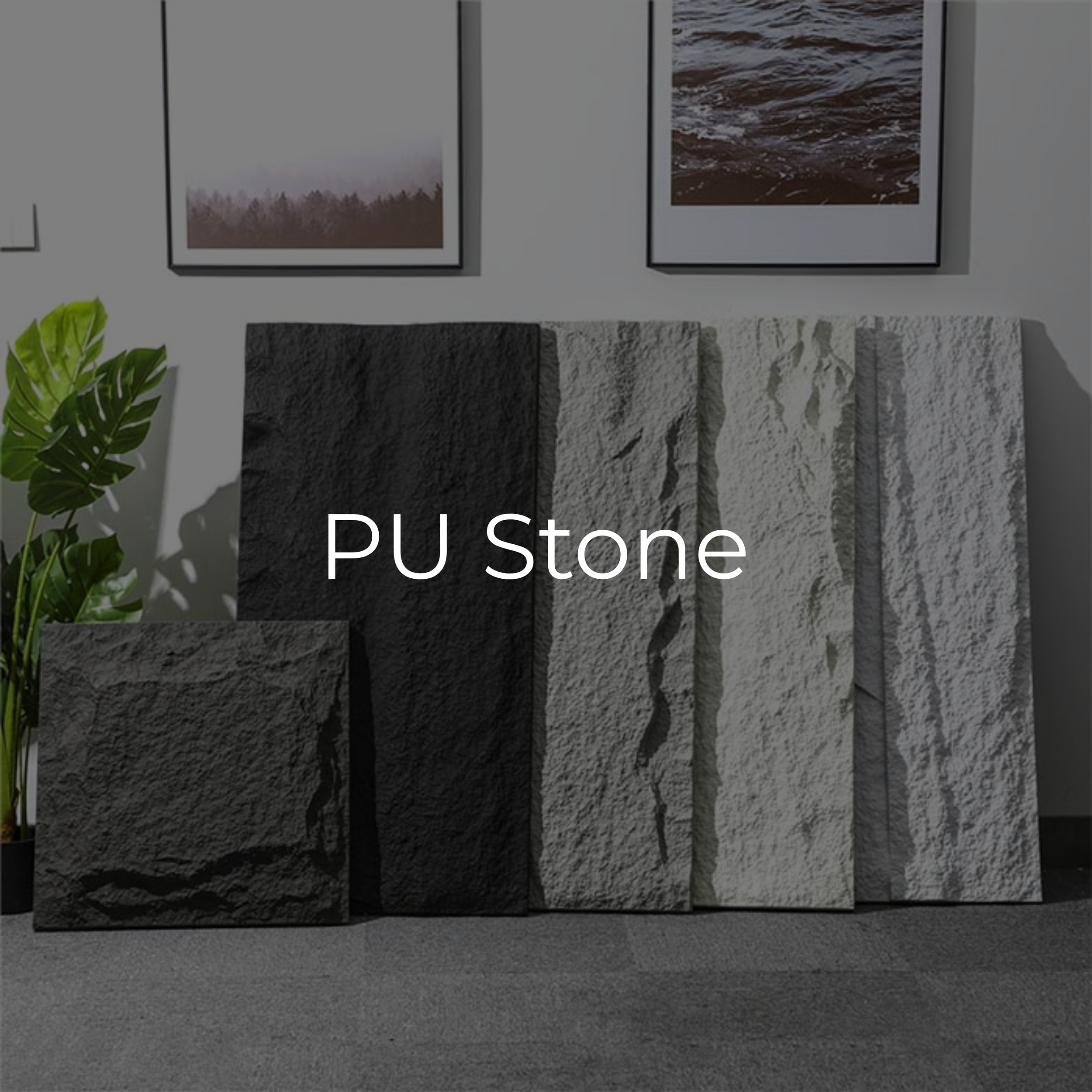 Display of various PU synthetic stone slabs in black, gray, and white colors, with framed landscape photographs on the wall and a green potted plant to the left.