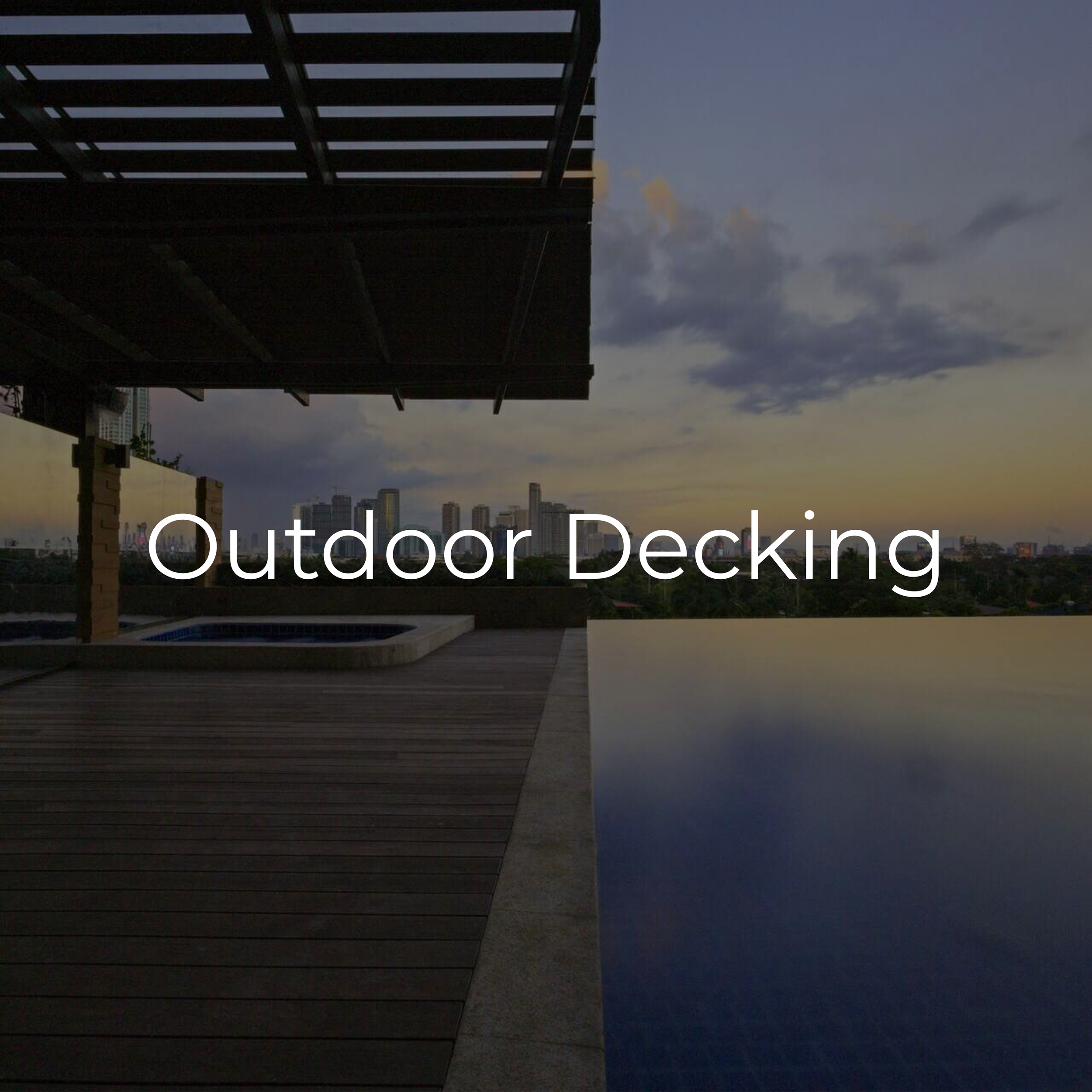 A rooftop outdoor decking area with wood flooring, a hot tub, and a view of city skyline during dusk or dawn.