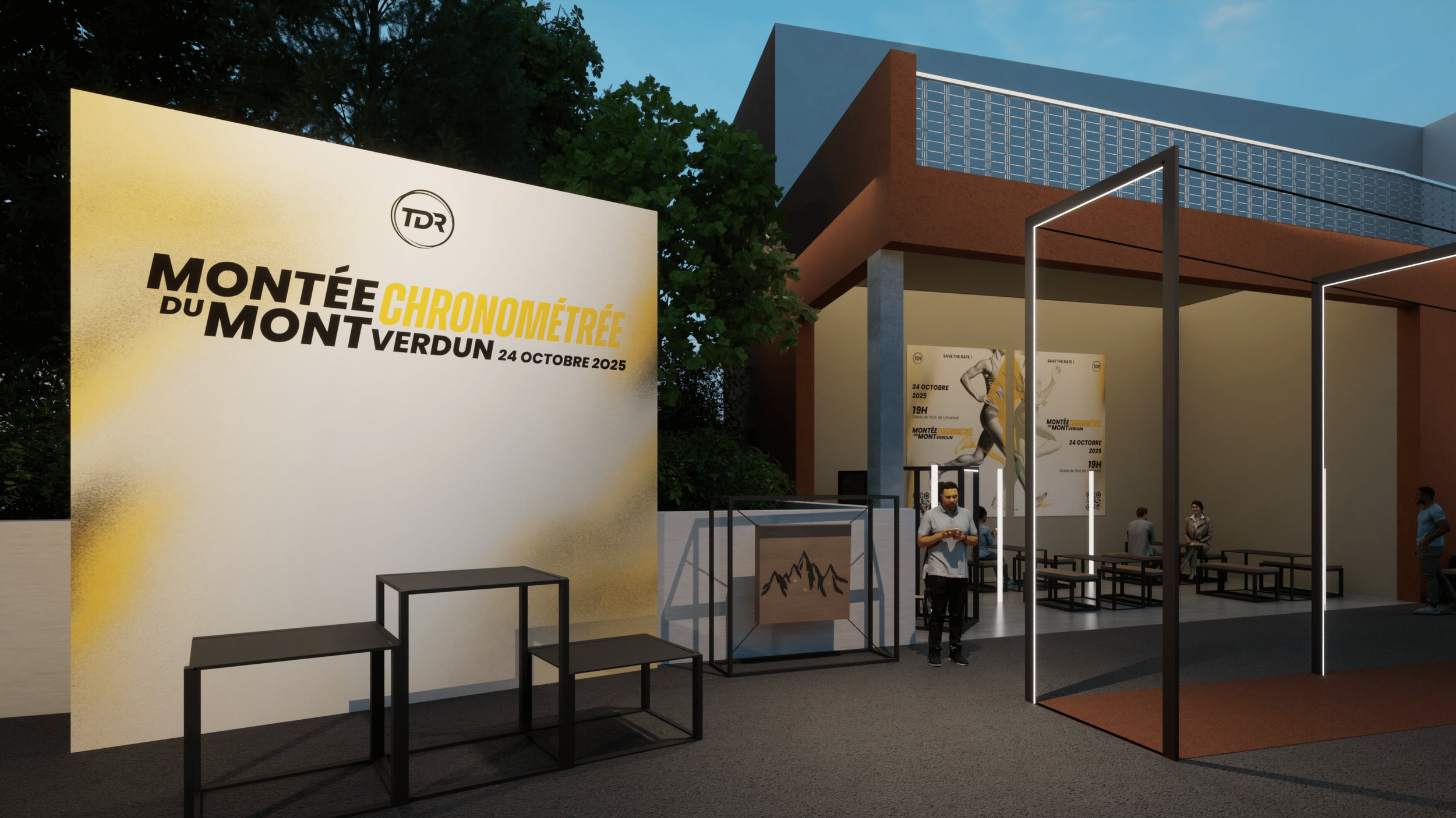 Affiche et décor pour un événement sportif : Montée du Mont Verdun le 24 octobre 2025, avec un espace d'accueil, des posters sur le mur, et quelques personnes présentes.