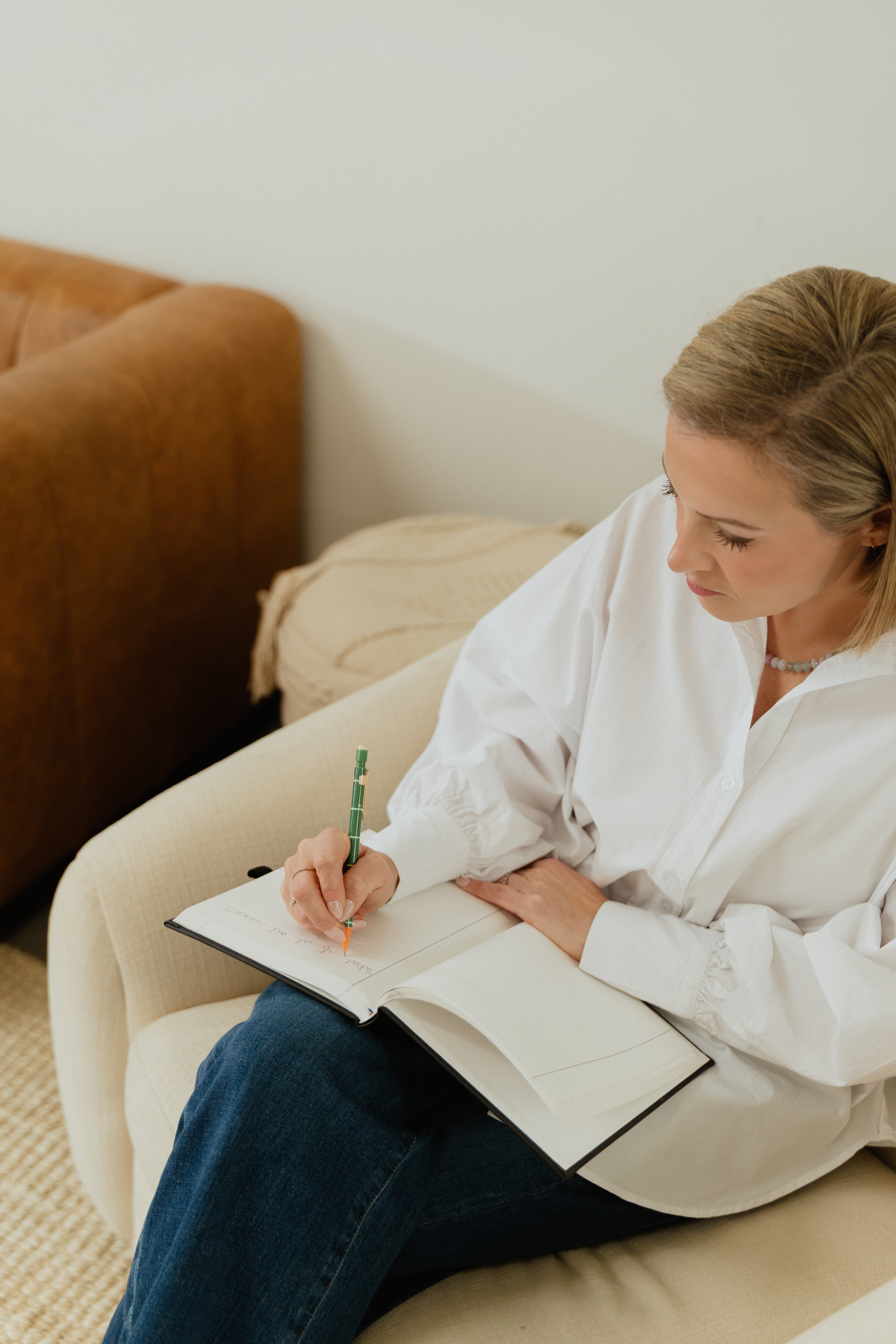 Marissa Kuhl, LCSW, taking notes during a therapy session.