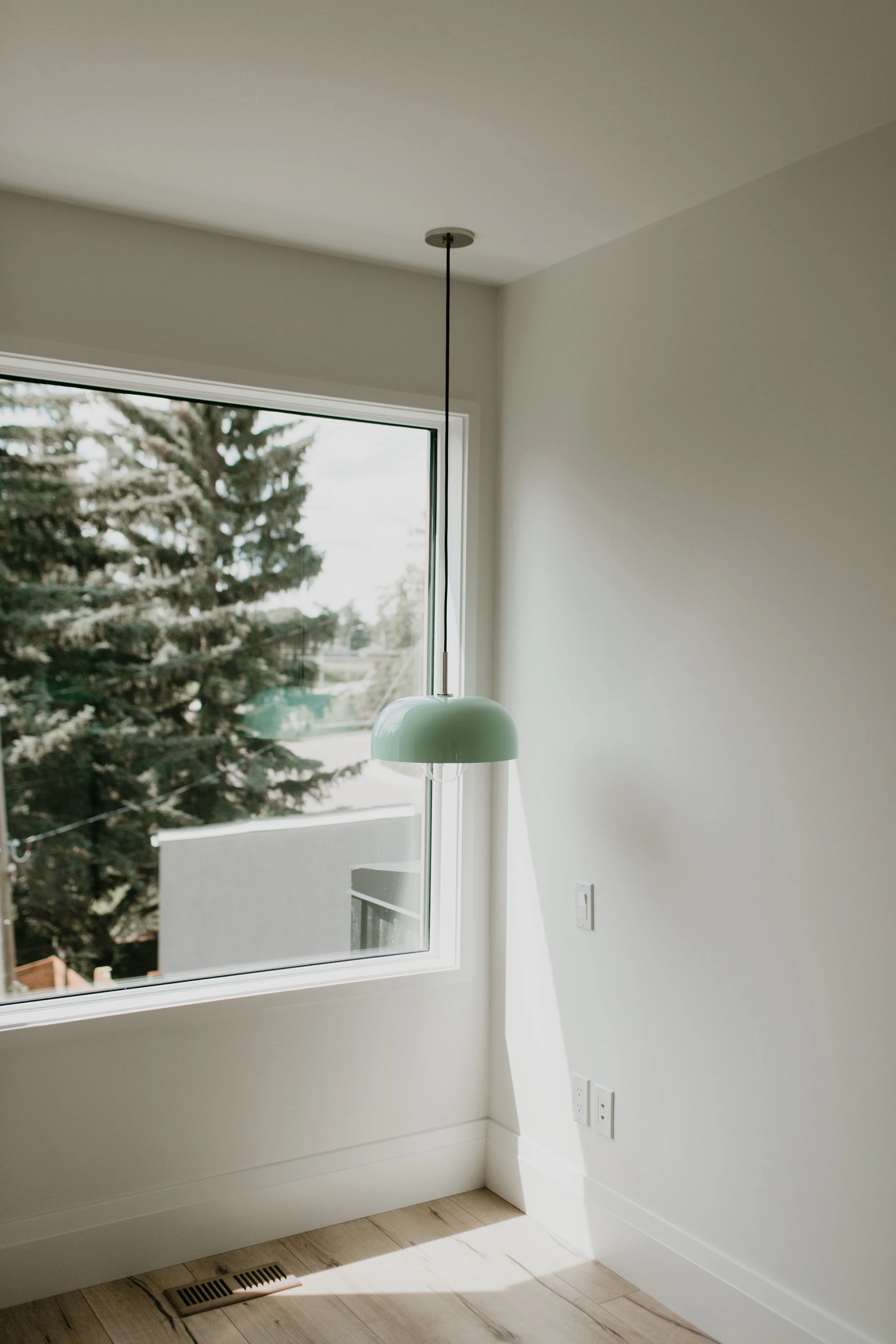 green pendant light in bedroom