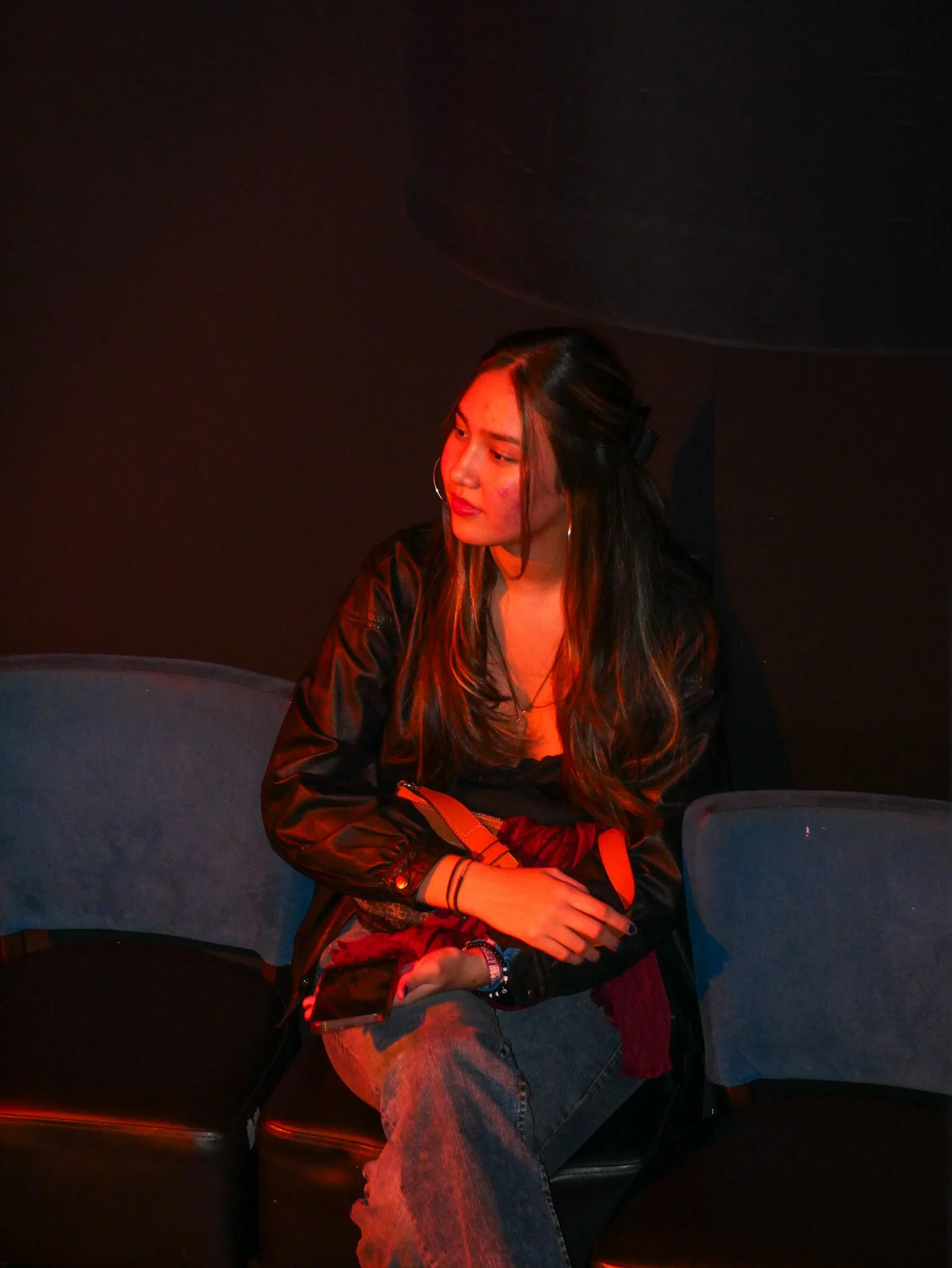 Person fishing at sunset by the water with dramatic clouds and reflected light