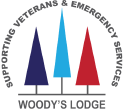 Logo for Woody's Lodge featuring a circular design with a mountain silhouette and three stylized trees in blue, gray, and red.