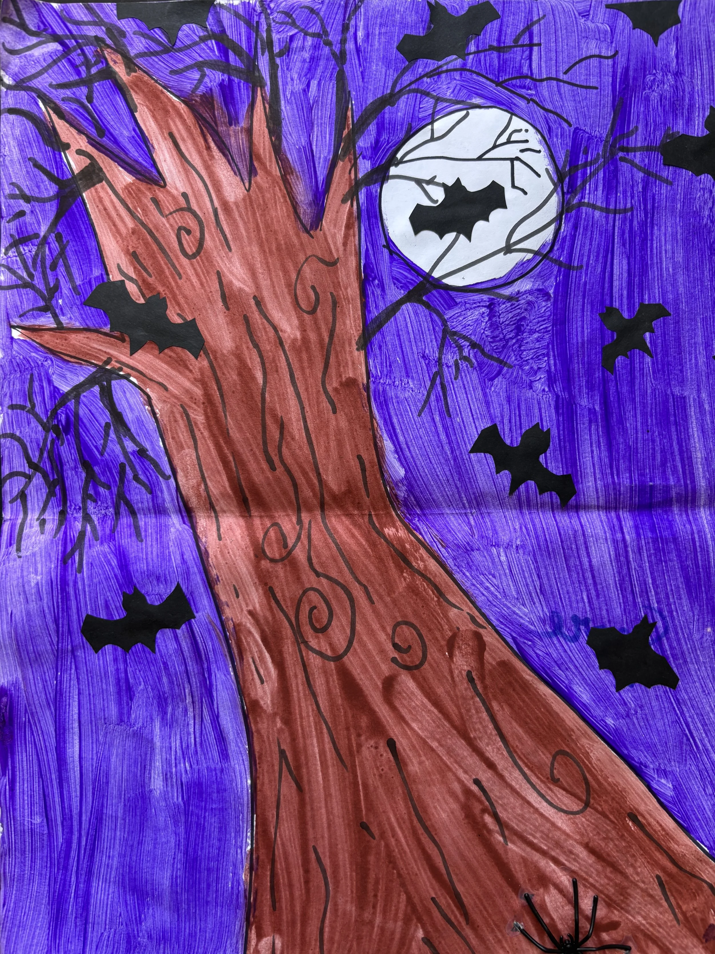 A colorful drawing of a spooky tree with a full moon in the background and several bats flying around.