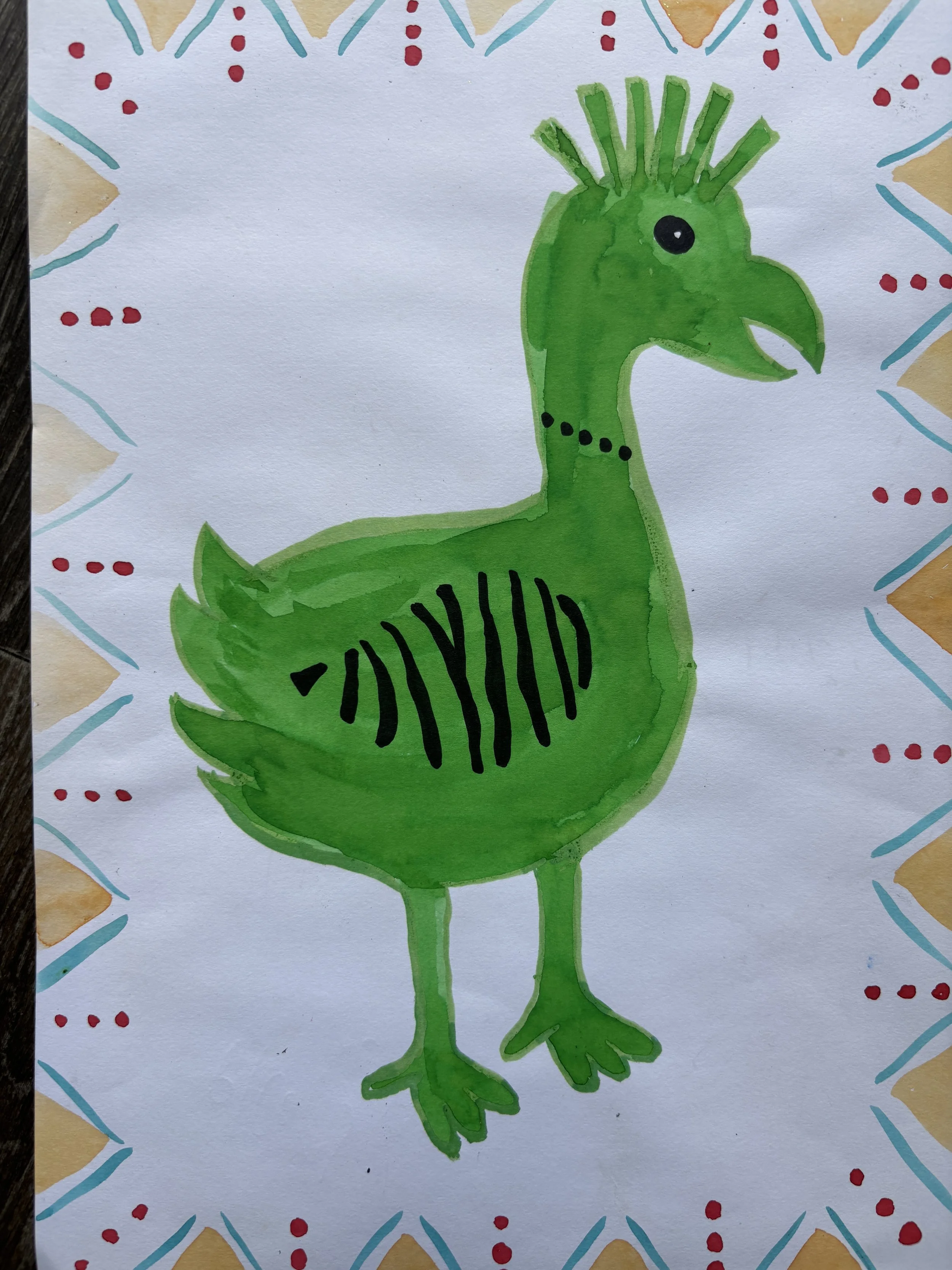Handmade drawing of a green bird with a beak, crest, black eyes, and striped pattern on its body, surrounded by decorative border designs.