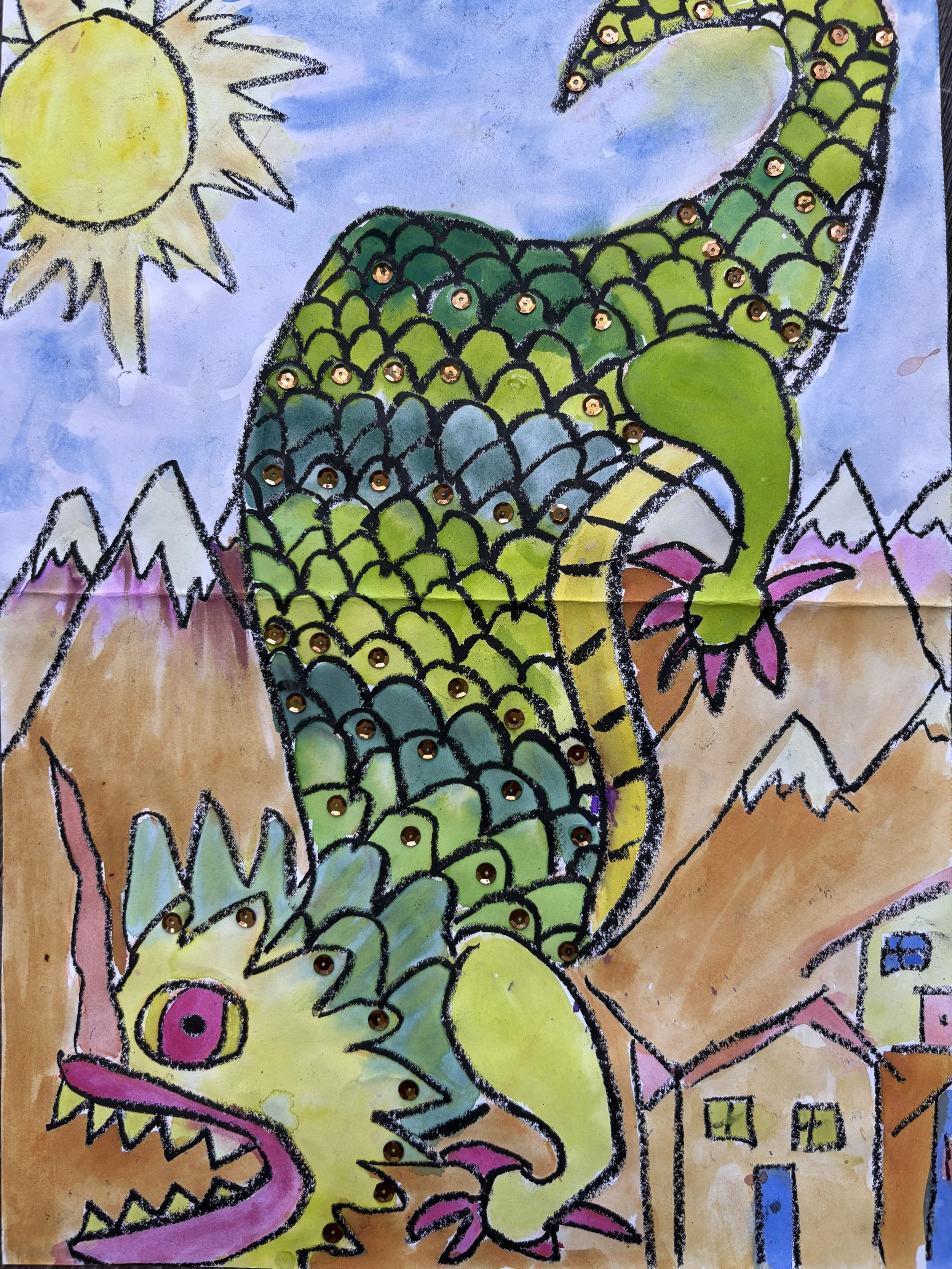 Colorful drawing of a large green dragon with scales, a pink eye, and an open mouth with sharp teeth. The dragon is in a mountainous landscape with a bright yellow sun, mountains with snow-capped peaks, and small houses with yellow walls and blue doo