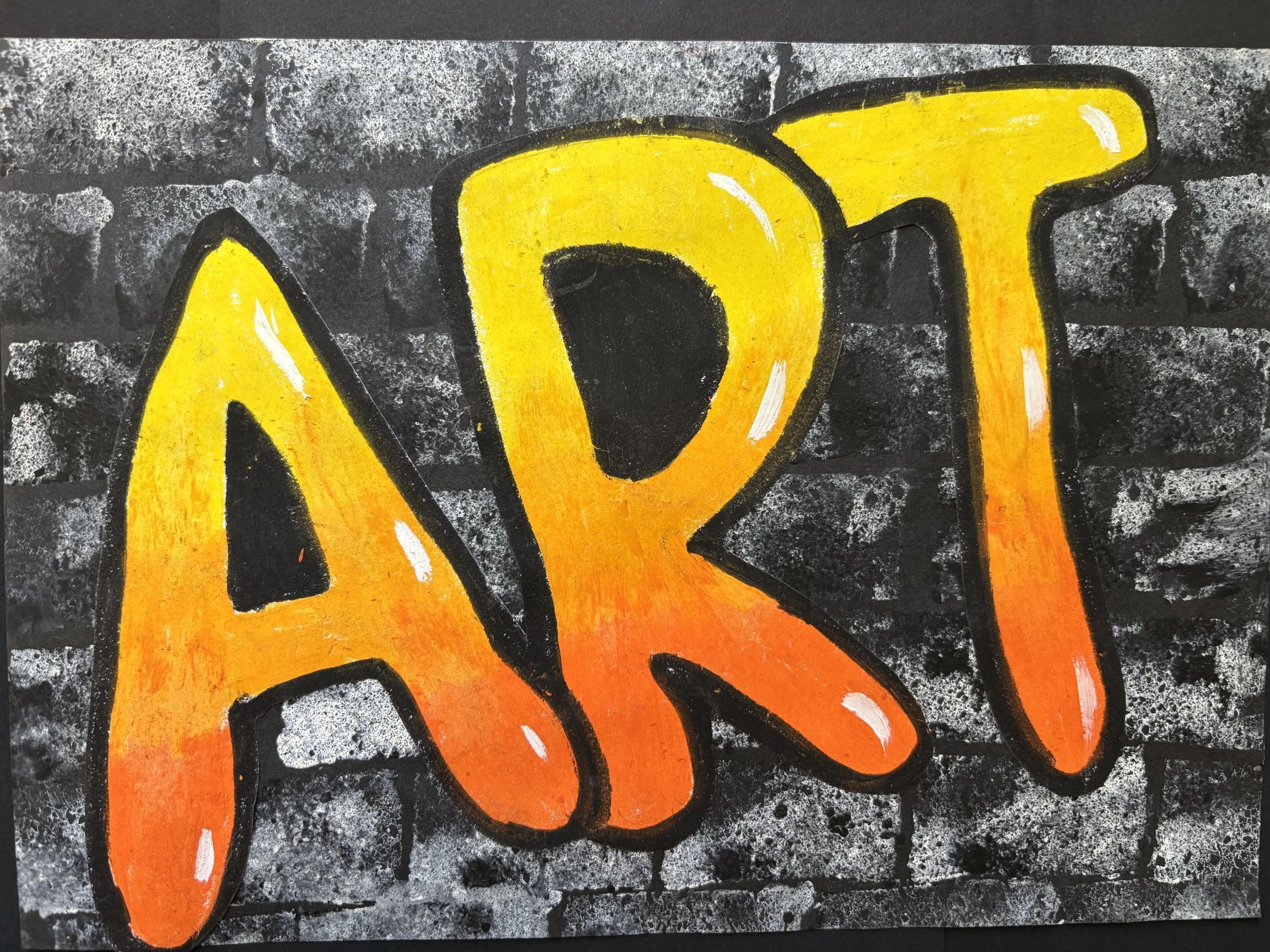 Graffiti art of the word 'ART' in bold, colorful letters with a gradient from yellow to orange, outlined in black on a gray brick wall.
