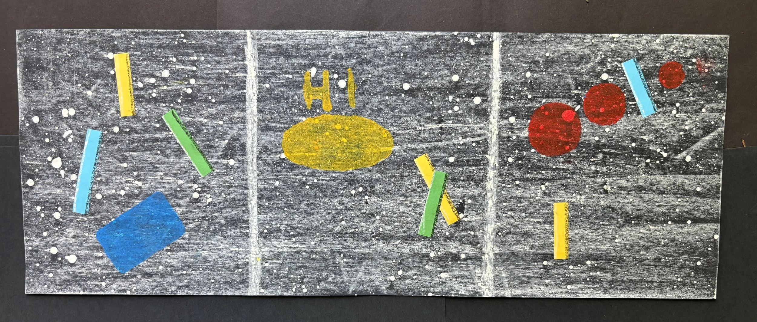 Painted hockey rink with colorful paper rectangles and circles, including a yellow oval with 'HI' written above, on a splattered black background.