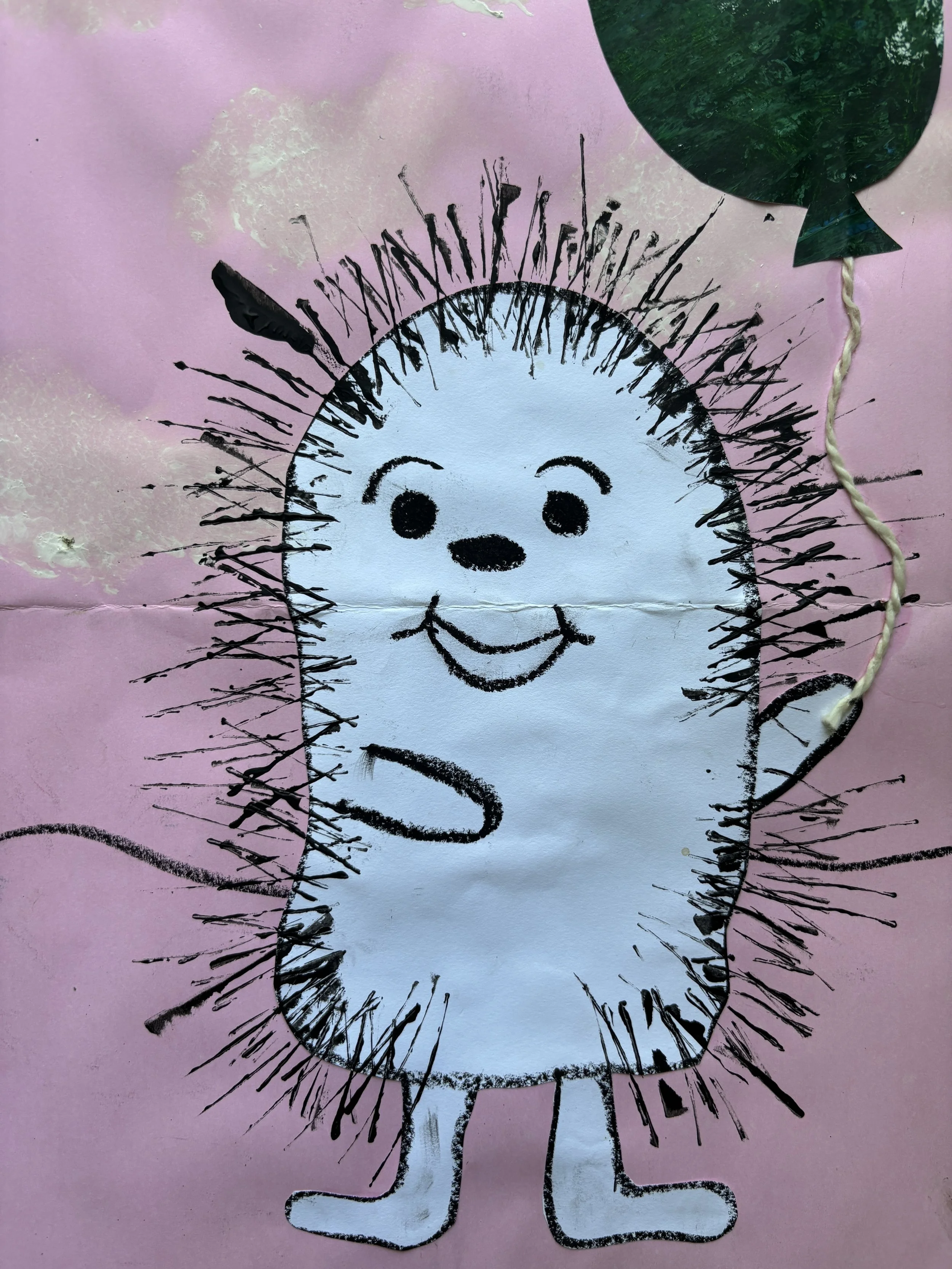 A children's drawing of a smiling cartoon hedgehog with a white body, black outline, and spiky quills, on pink background with a green balloon nearby.
