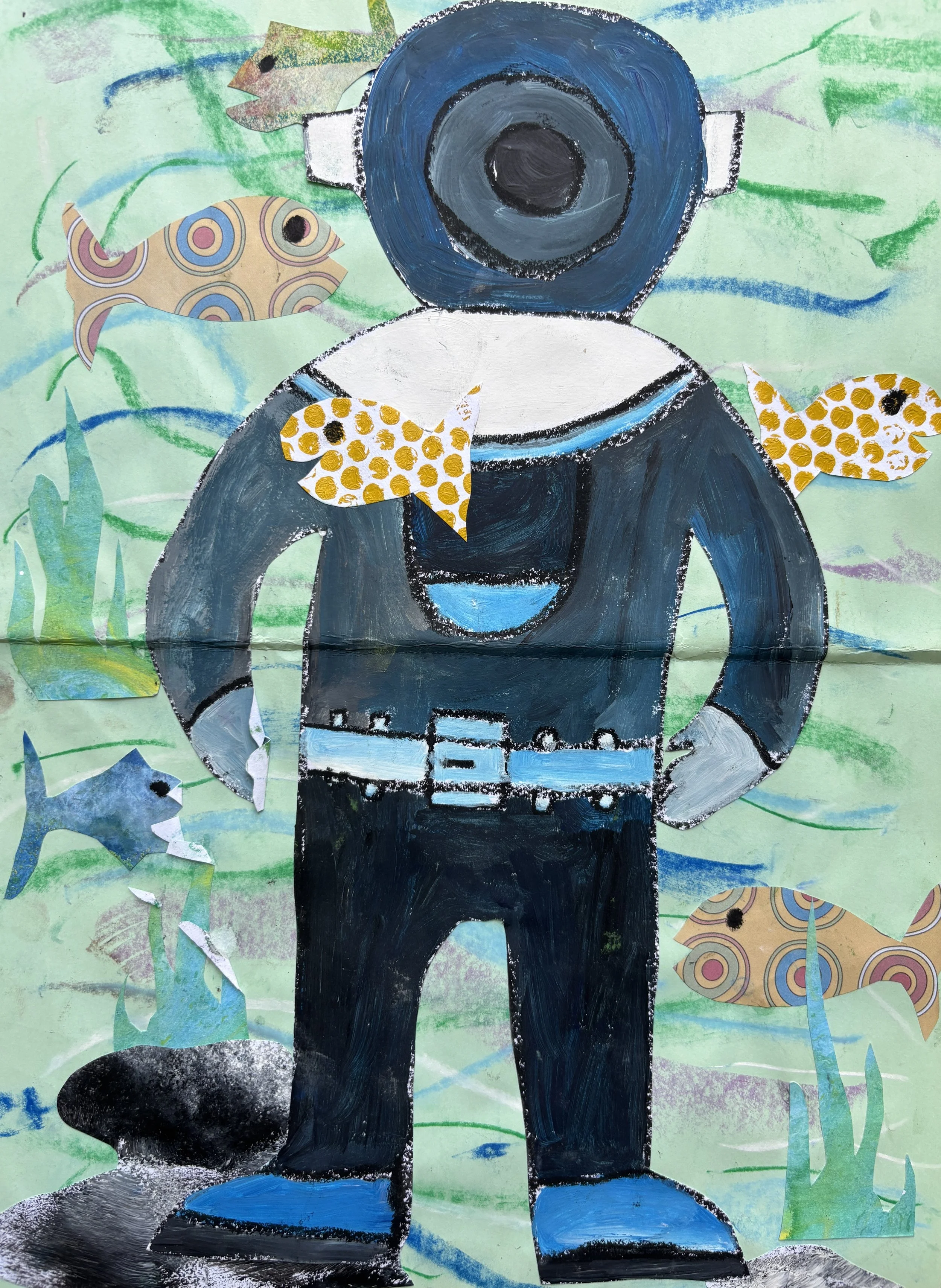 Child's artwork of a person in a scuba diving suit surrounded by fish and seaweed.