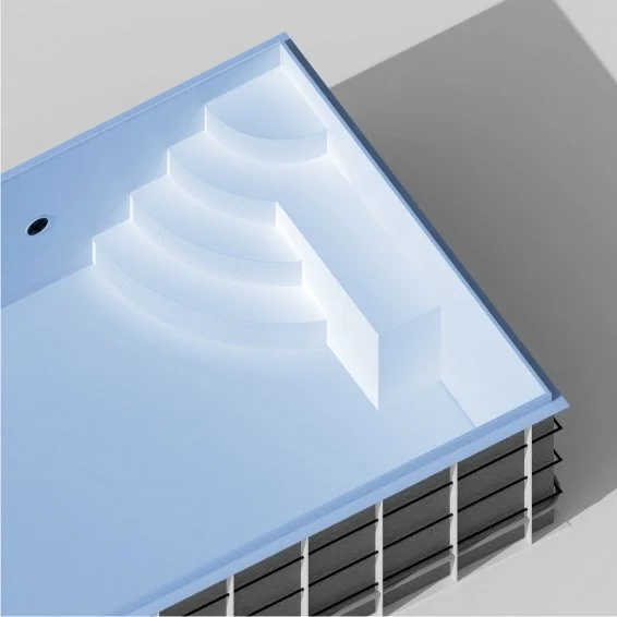 A modern, empty indoor swimming pool with built-in steps and a light blue interior.