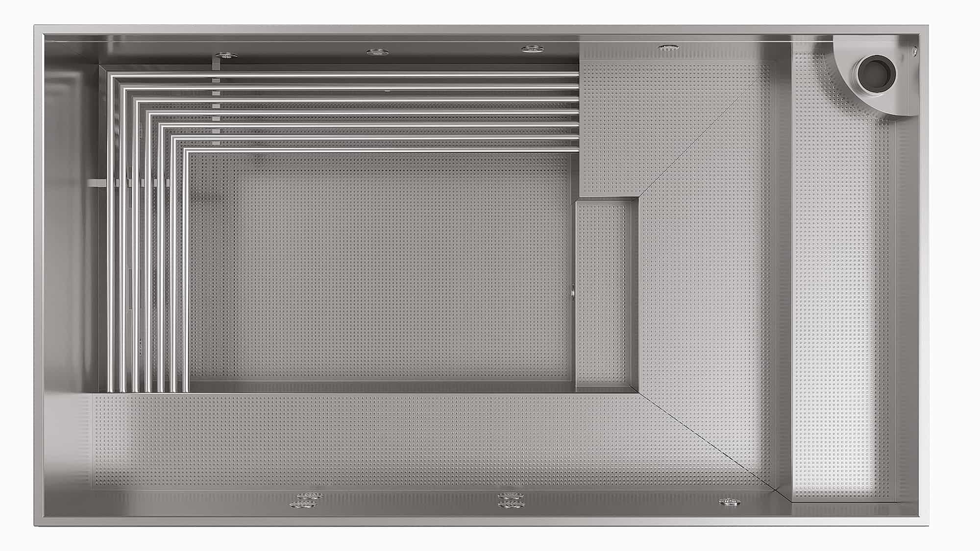 Top view of a large stainless steel kitchen sink with multiple compartments and perforated drainage areas.
