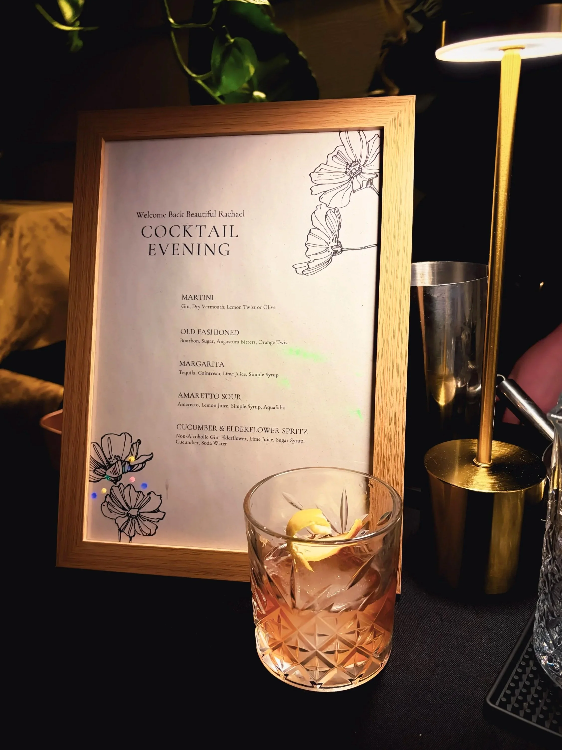 Old Fashioned cocktail with a cocktail list of a martini, old fashioned, amaretto sour, and cucumber and elderflower spritz