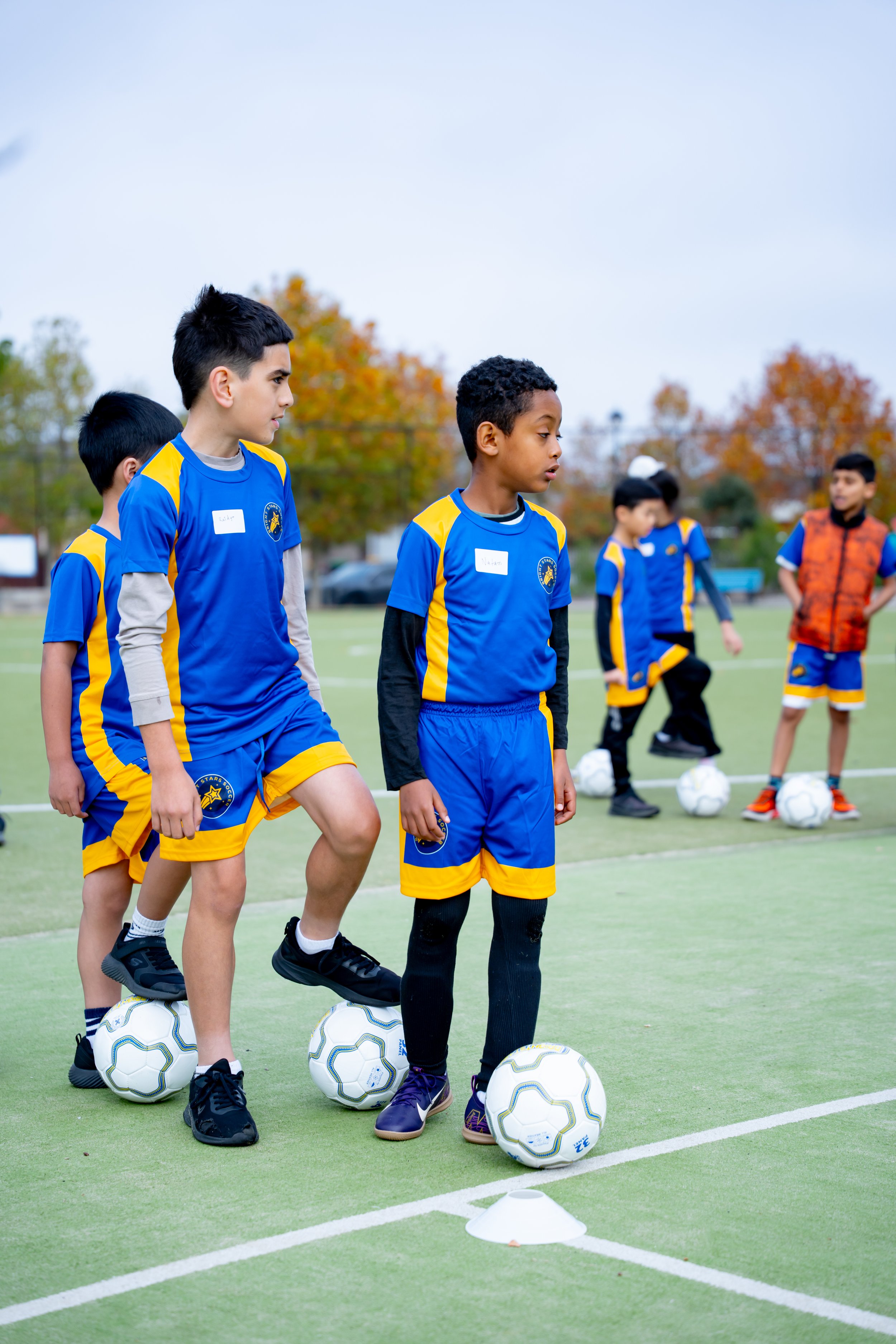 Children participating in a soccer drill on an outdoor field